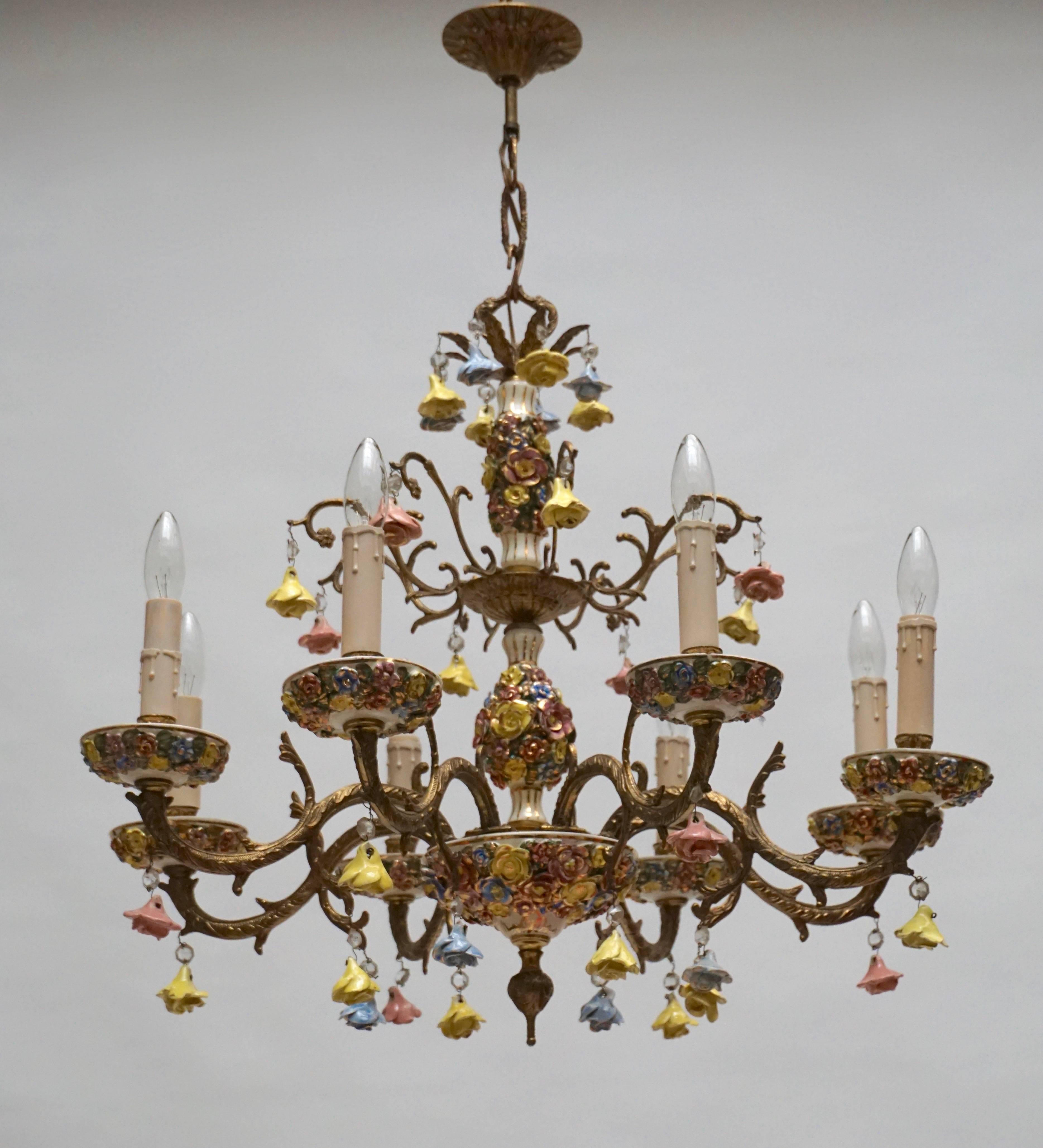 Wonderful eight-light handcrafted gilt metal with porcelain flowers chandeliers.
Eight E14 bulbs.
Measures: Diameter:68 cm.
Height fixture 58 cm.
Total height with the chain:80 cm.