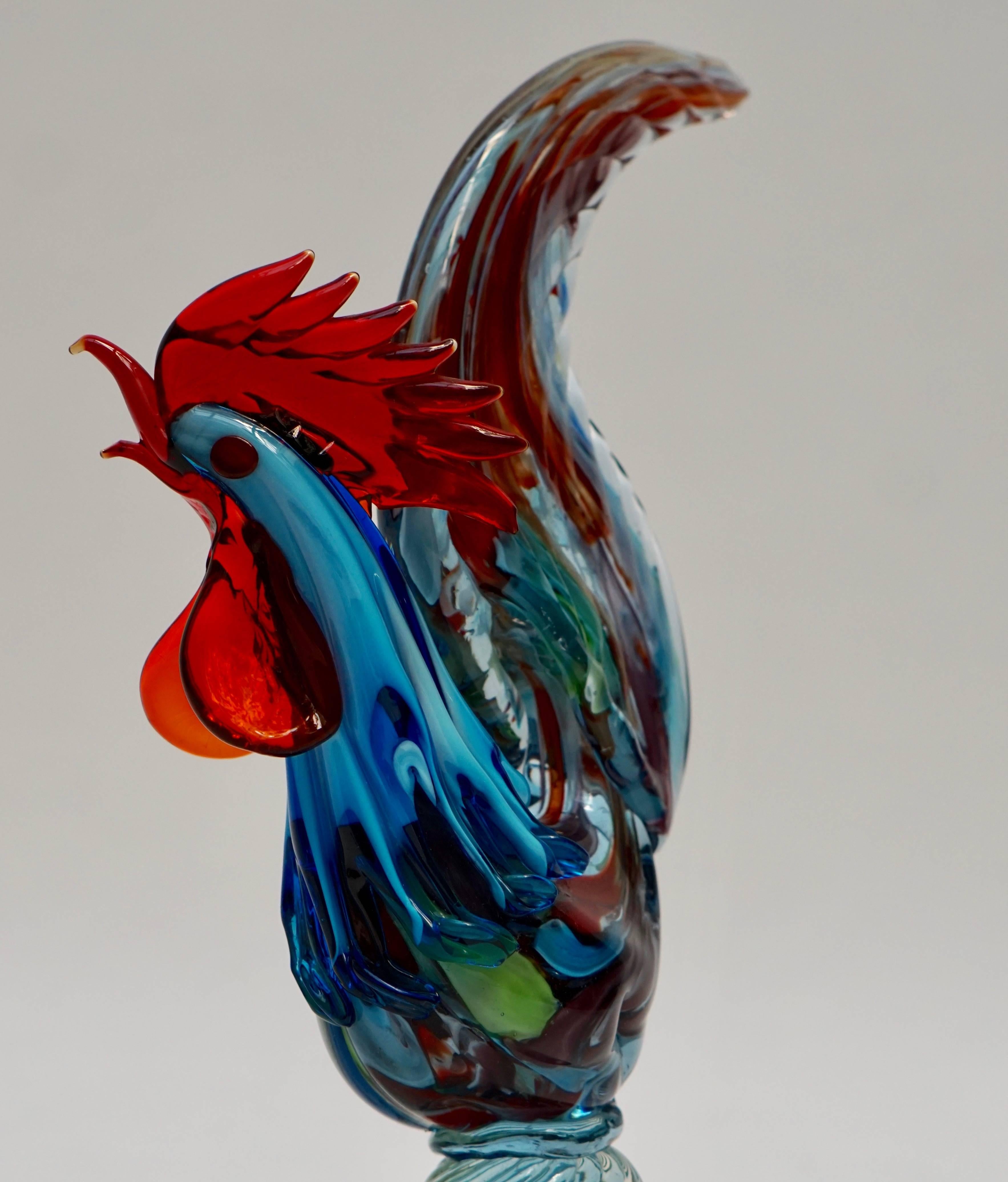 Murano glass sculpture of a rooster.
Italian Mid-Century Modern Murano handblown glass rooster sculpture. Having beautiful multi colors and clear glass.

Measures: 
Height 39 cm.
Width 25 cm.
Depth 11 cm.