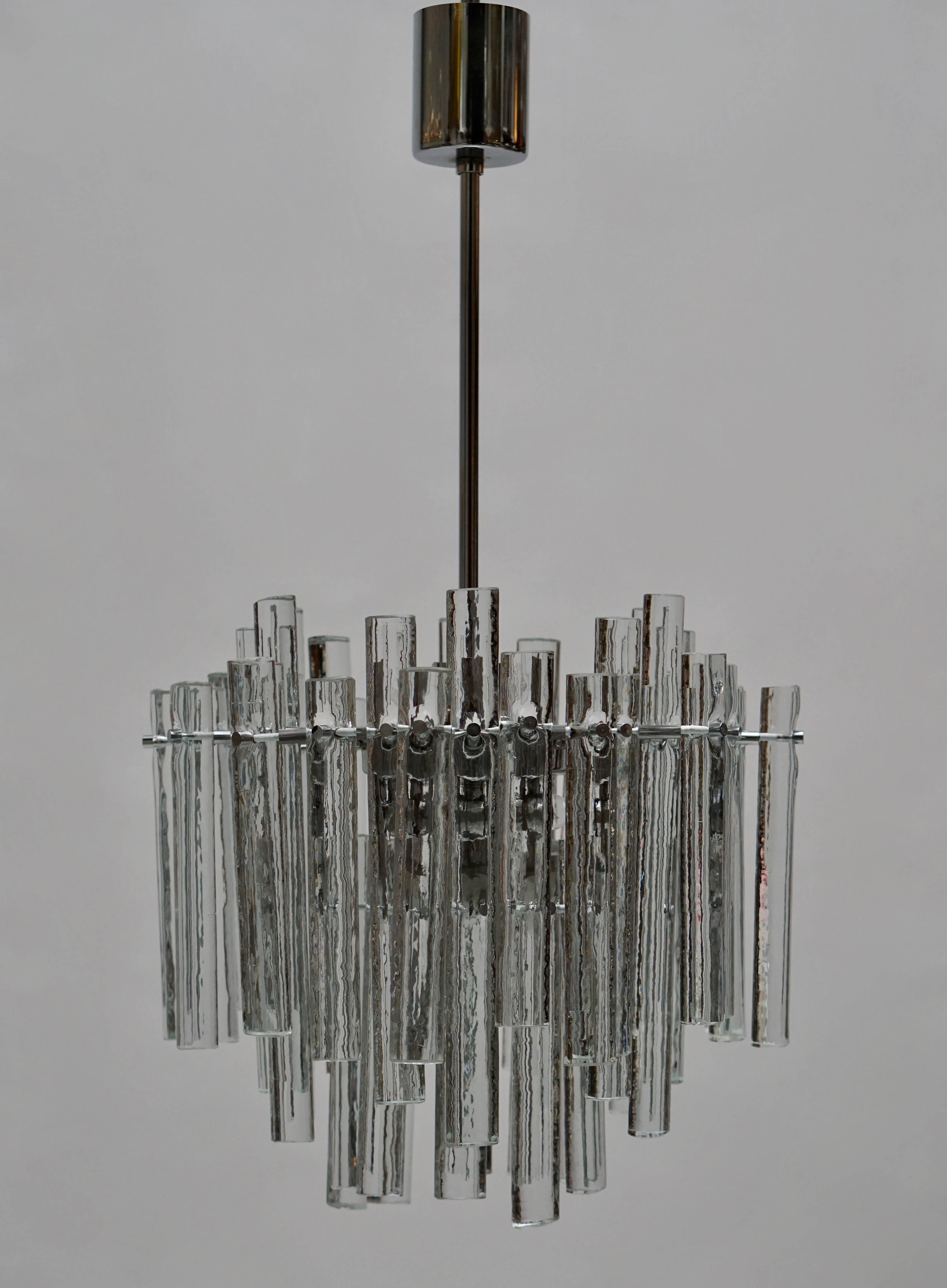 A beautiful Kinkeldey chandelier with 46 clear handmade ice crystals in varying lengths.
New wiring, three E-14 base bulbs and one E27 bulb up to 40 watts per bulb.

Materials: Chromed metal, 46 clear crystal glass handmade “ice blocks”. Metal