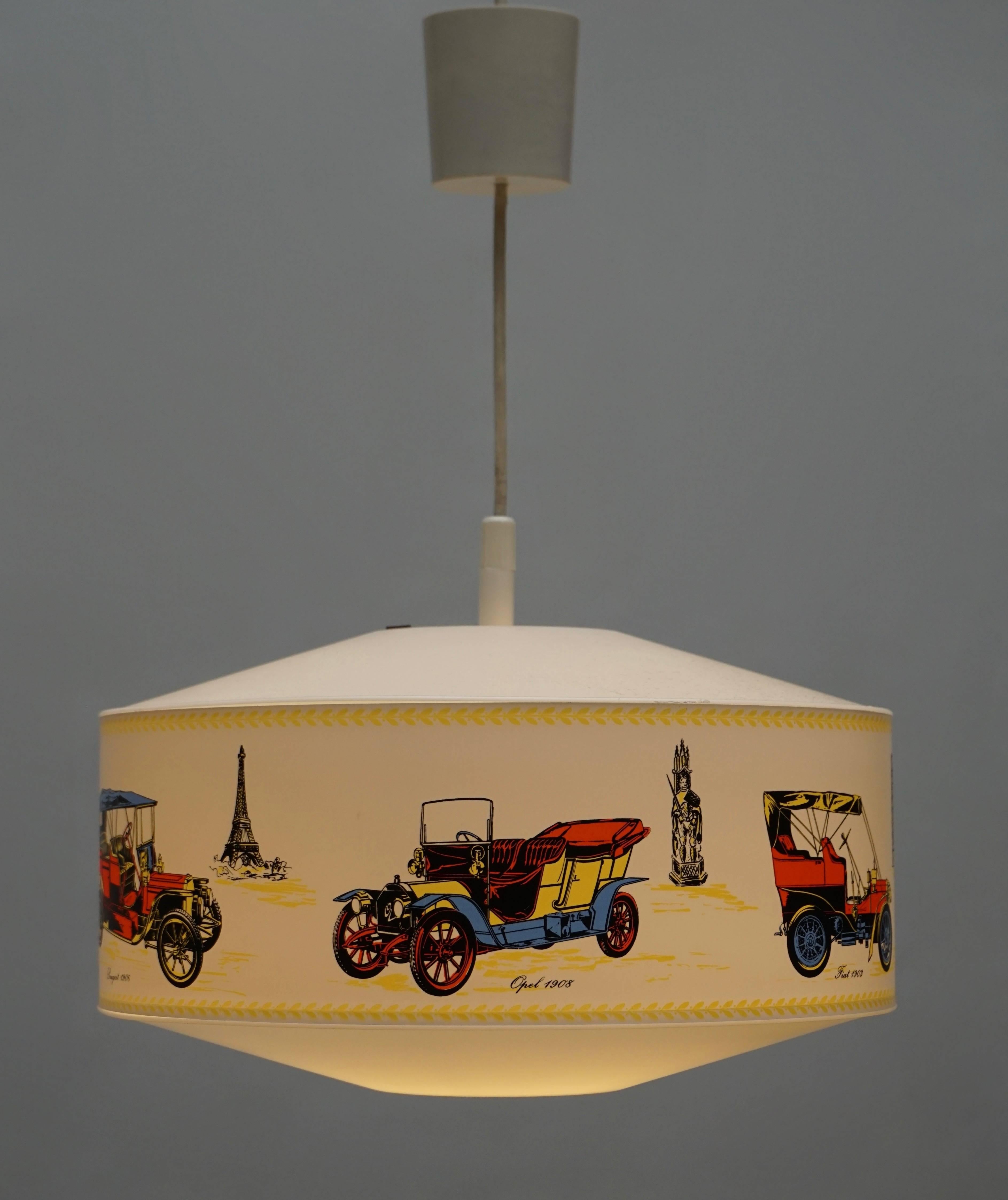 Pendant light decorated with vintage cars, statue of liberty, Eiffel tower, tower of Pisa.
Measures: Diameter 35 cm.
Height fixture 18 cm.
Total height 60 cm.