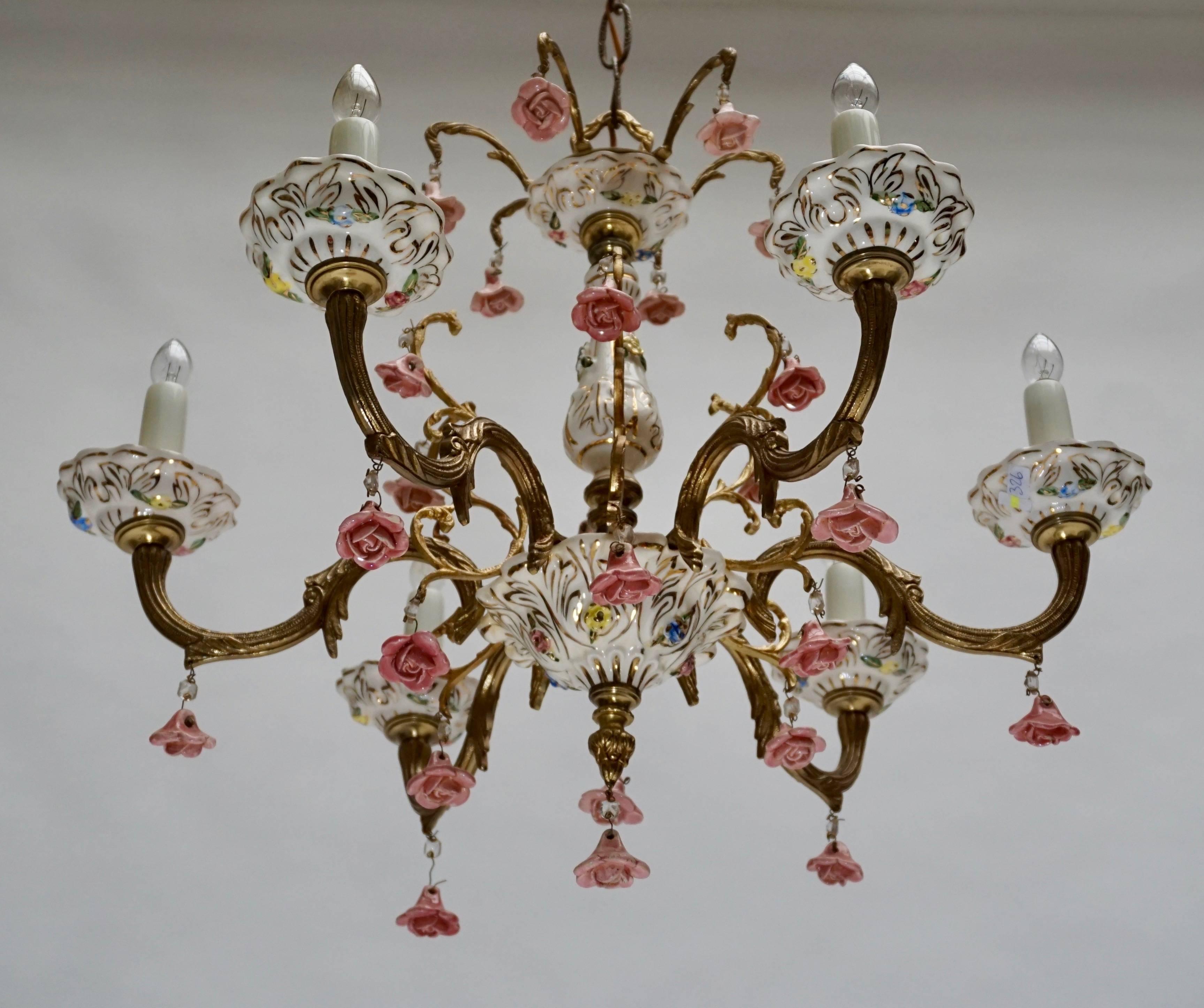 Wonderful six-light handcrafted gilt metal with porcelain flowers chandeliers.
Six E14 bulbs.
Measures: 
Diameter 57 cm.
Height fixture 45 cm.
Total height with the chain 90 cm.