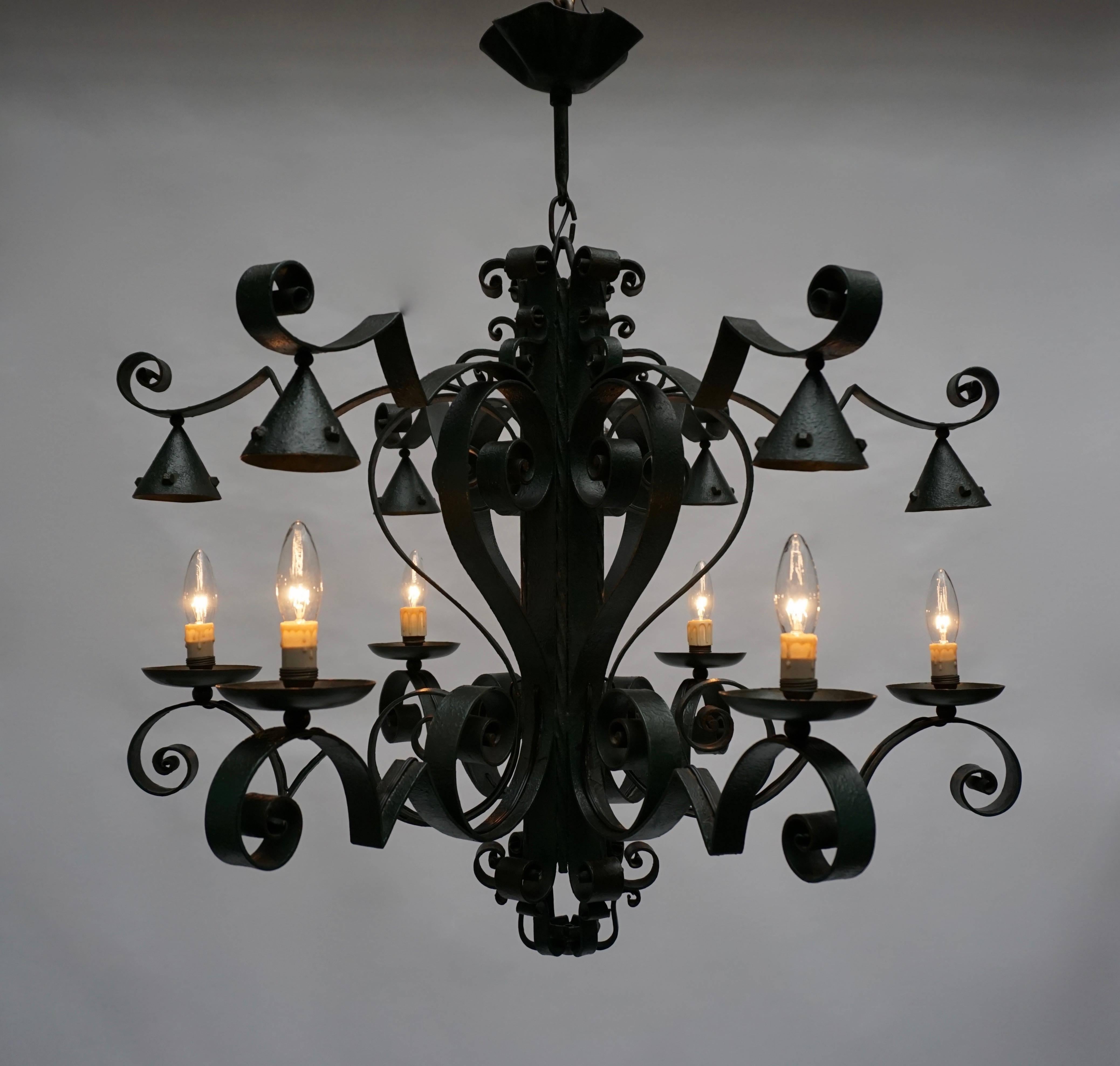 A large French six-light wrought iron chandelier. Beautifully crafted iron work and nice old patina.
More photos available upon request.

Measures: Diameter 80 cm.
Height 80 cm.
Maximum height with the original chain is 120 cm.