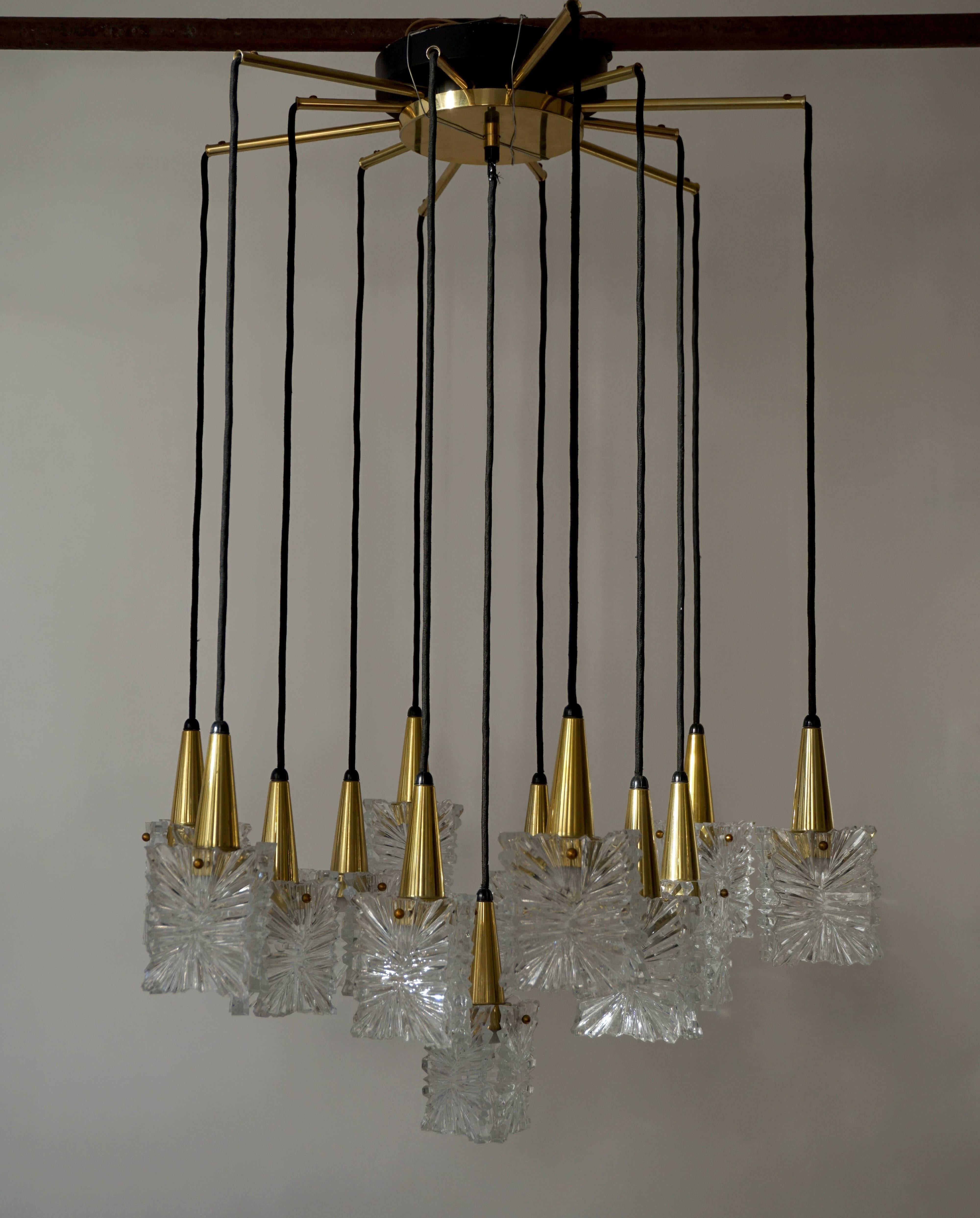 Glass and brass chandelier by RAAK, Netherlands.
There are four extra glass elements.