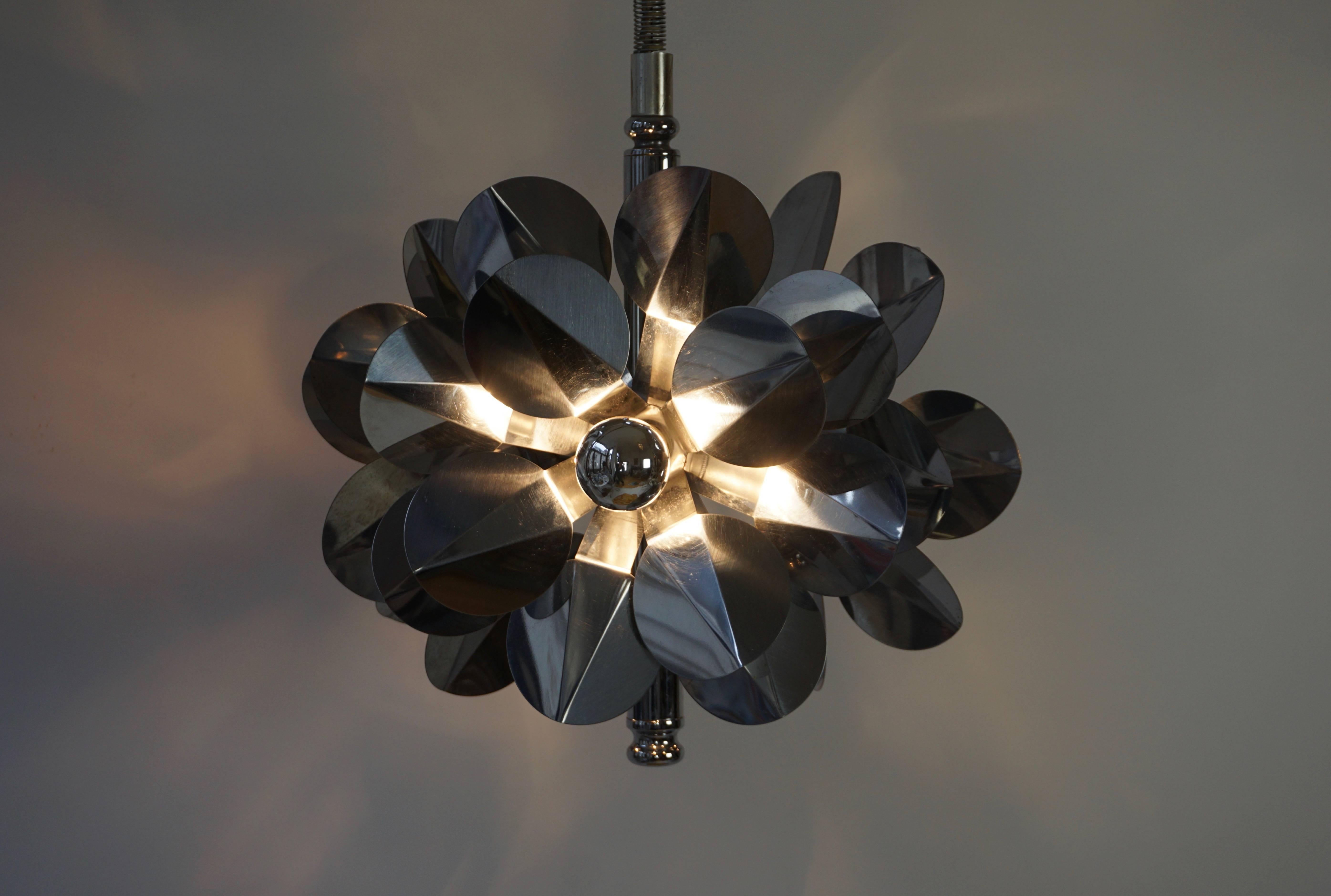 Rare Italian chrome flower chandelier from the 1960s presumably by Reggiani. The reflector lamps give an incredible effect on the shiny metal.

The minimum length of the suspension system is 70 cm.
The maximum length is 120 cm.
Diameter: 40 cm.