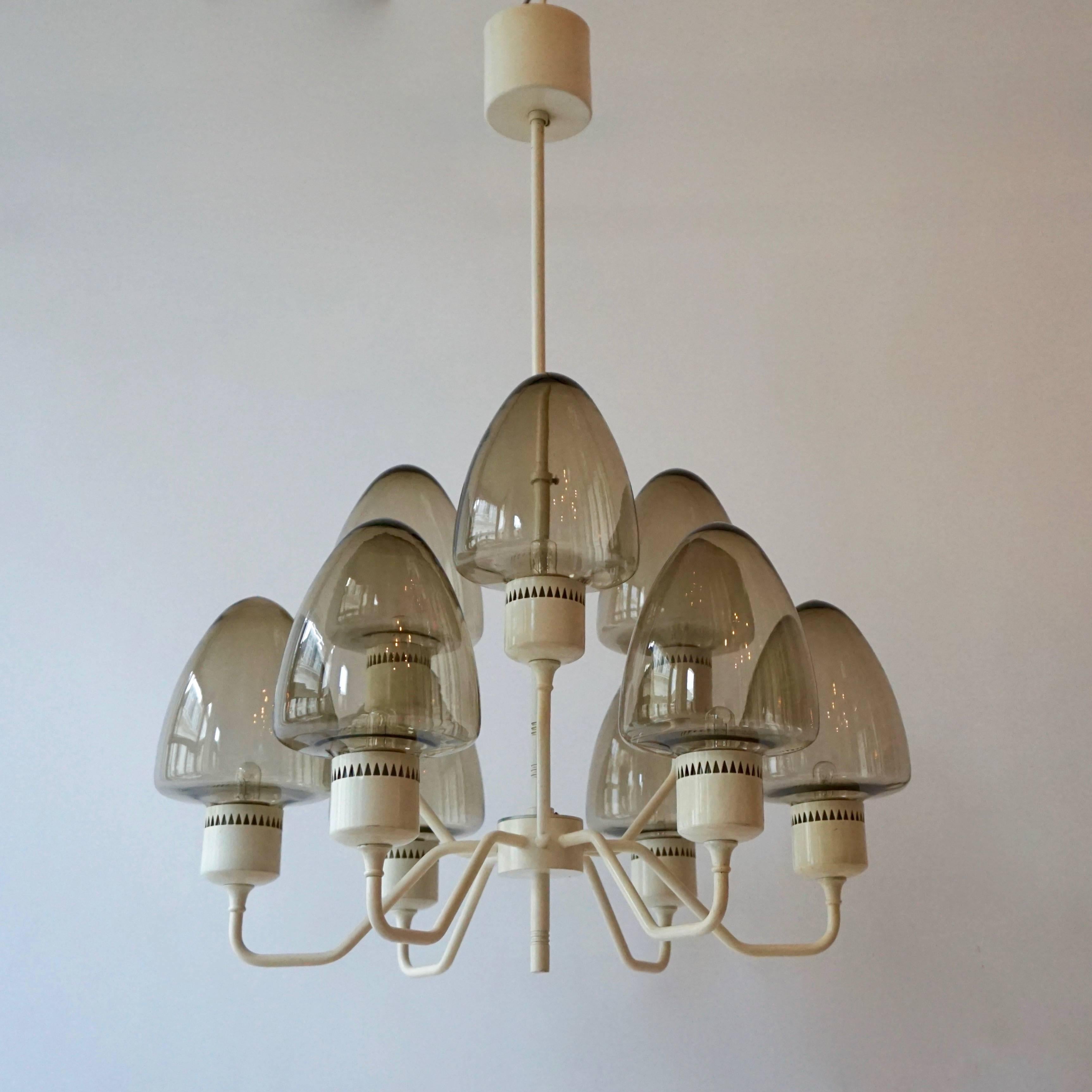Swedish chandelier with nine arms, each featuring a glass globe . 
Takes nine candelabra size bulbs E14.
Labeled Hans-Agne Jakobsson, Markaryd Sweden.