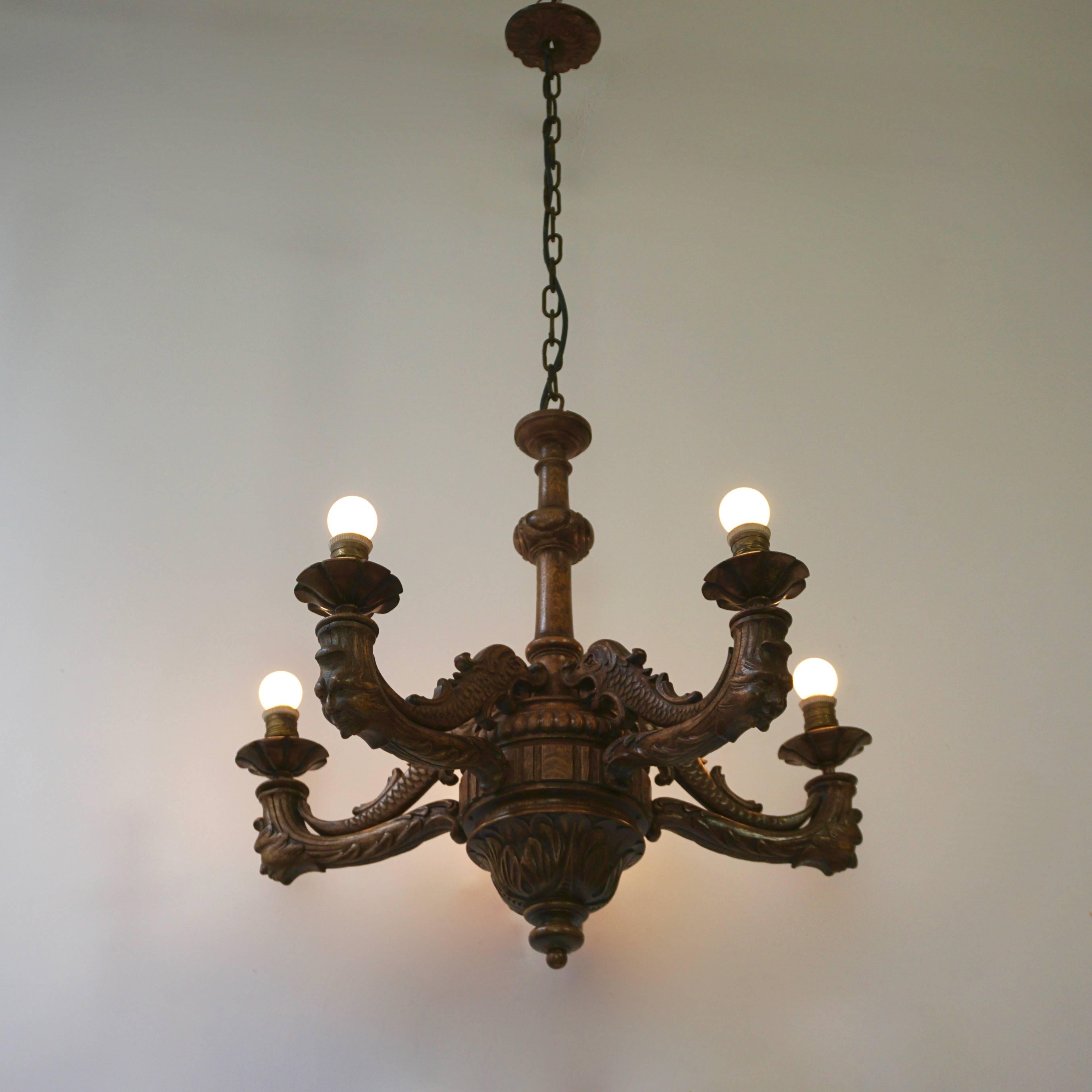 Antique carved wood chandelier with five arms. Excellent craftsmanship. Comes with chain and original carved wood canopy.

Total height with the chain is 125 cm.
Diameter is 70 cm.
   