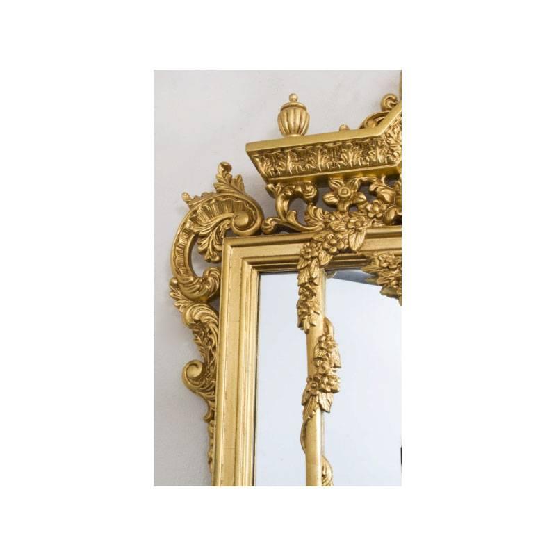 This is a gorgeous and very decorative richly hand-carved rectangular French double framed giltwood mirror dating from the last quarter of the 20th century.

There is no mistaking its unique quality and design, which is certain to make it a