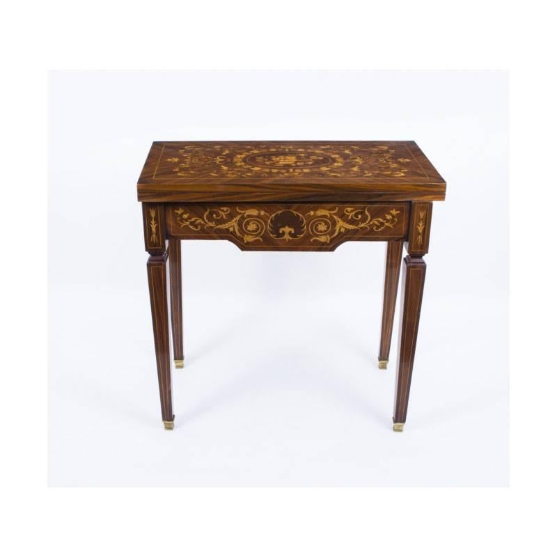 This is a lovely French rosewood games table in the Louis XV style, dating from the last quarter of the 20th century. 

The table is elaborately decorated with marquetry of musical instruments and swirls.

The craftsmanship and finish are second to