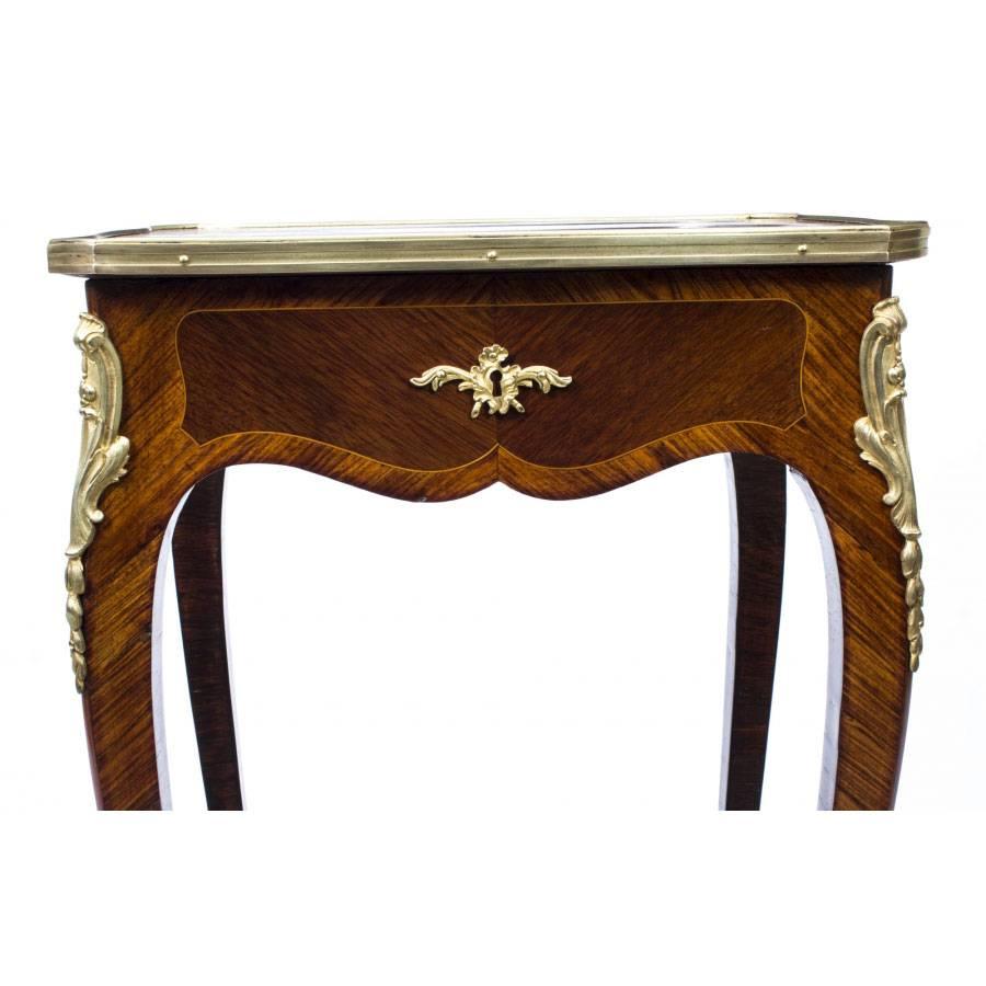 This is a beautiful antique French Louis XV Revival ormolu mounted occasional table, circa 1860 in date, which will enhance any room in your house.

The mahogany top is beautifully quarter veneered and crossbanded in kingwood, the attention to
