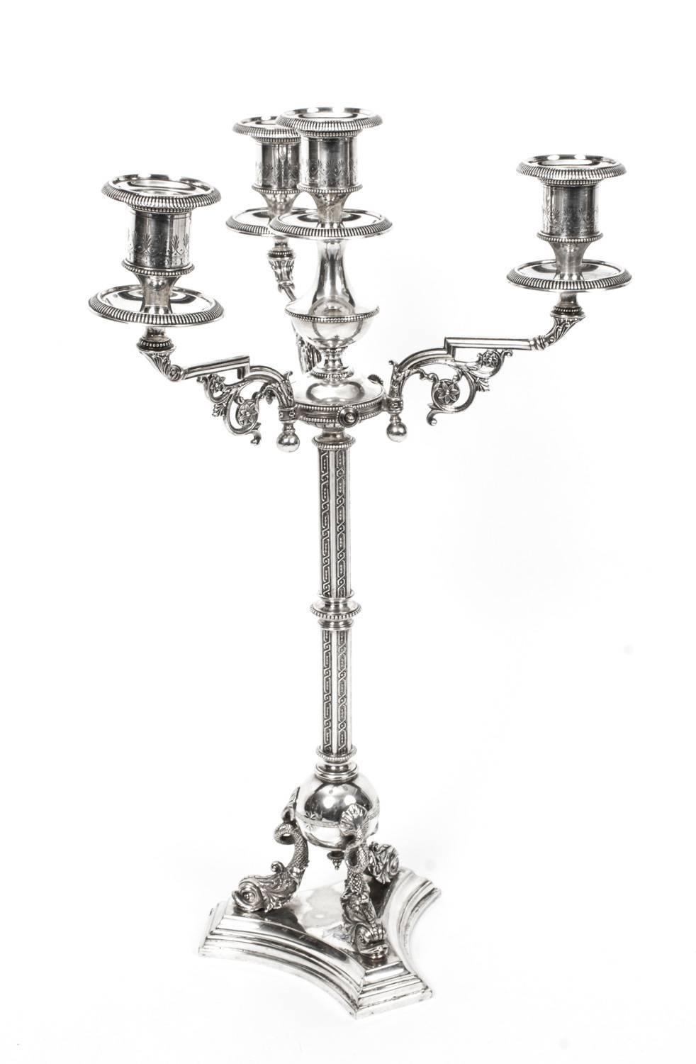 This is a stunning pair of antique Victorian silver plated, four light, three-branch table candelabra, circa 1880 in date, and bearing the mark of the renowned silversmiths Horace Woodward & Co, of Birmingham England.

The candelabra feature