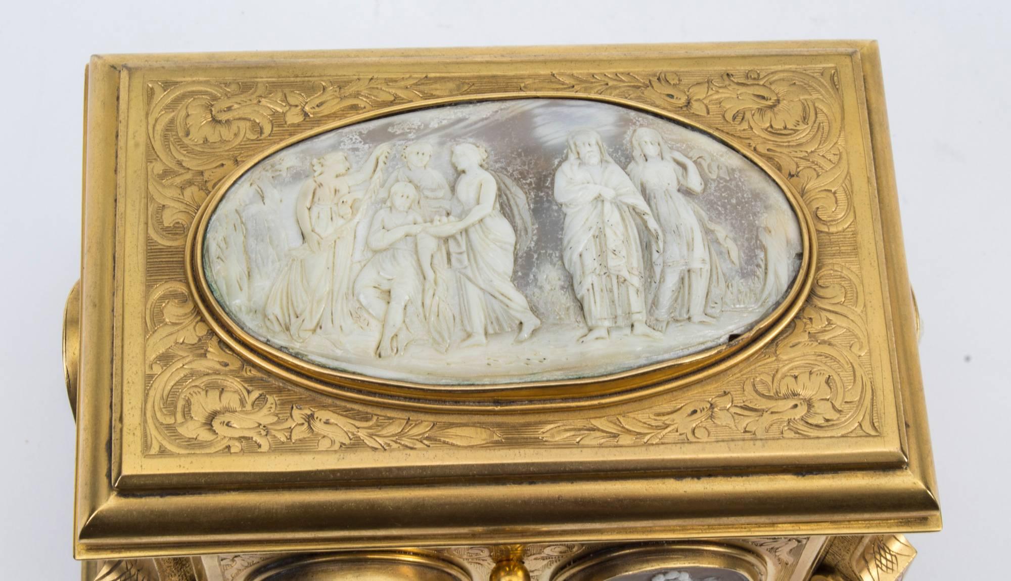 This is a wonderful antique French ormolu and carved cameo shell mounted jewelry casket, retailed by the renowned master cabinet maker, Tahan of Paris, and circa 1870 in date.

Of rectangular form, the hinged lid and sides are inset with