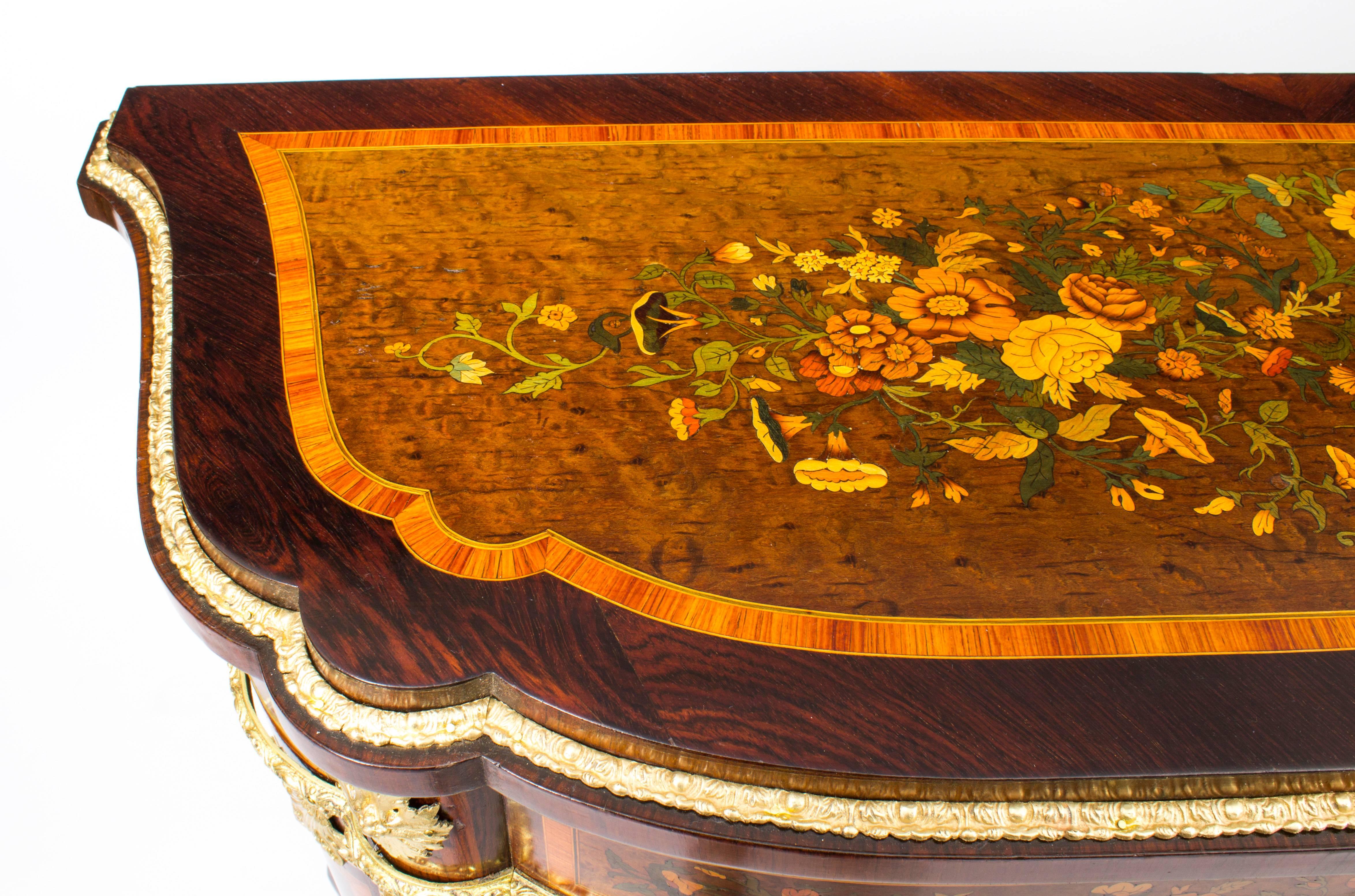 This is a stunning and imposing antique French ormolu-mounted, amboyna, marquetry. gonzalo alves and walnut side cabinet, circa 1850 in date.

The entire piece highlights the unique and truly exceptional pattern of the floral marquetry which is set