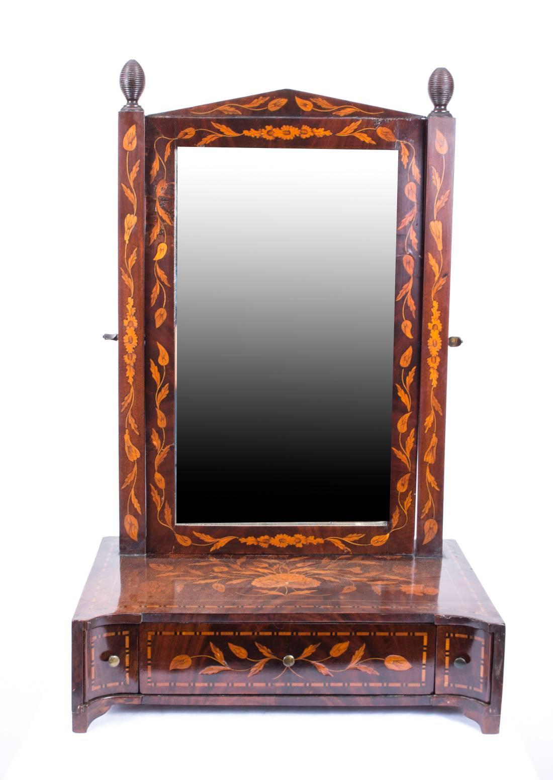 This is a beautiful antique Dutch dressing table mirror, dating from the late 18th century.

It is made from mahogany with exquisite floral marquetry decoration and has a useful drawer for storing your brushes and combs. 

Liven your dressing