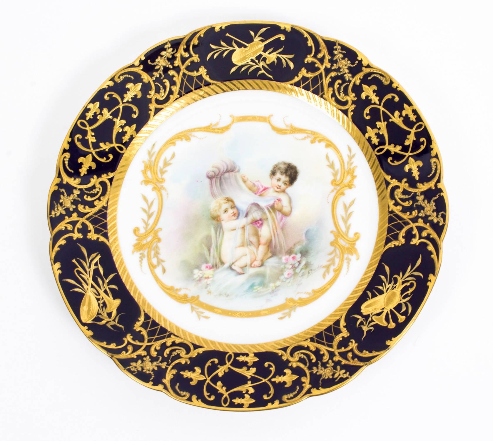 This is an absolutely fabulous and decorative antique pair of Sevres style porcelain cabinet plates, signed F.Boucher, circa 1900 in date.

Both beautifully painted with amorini with raised gilt and Bleu du Roi borders.

The plates bear the the