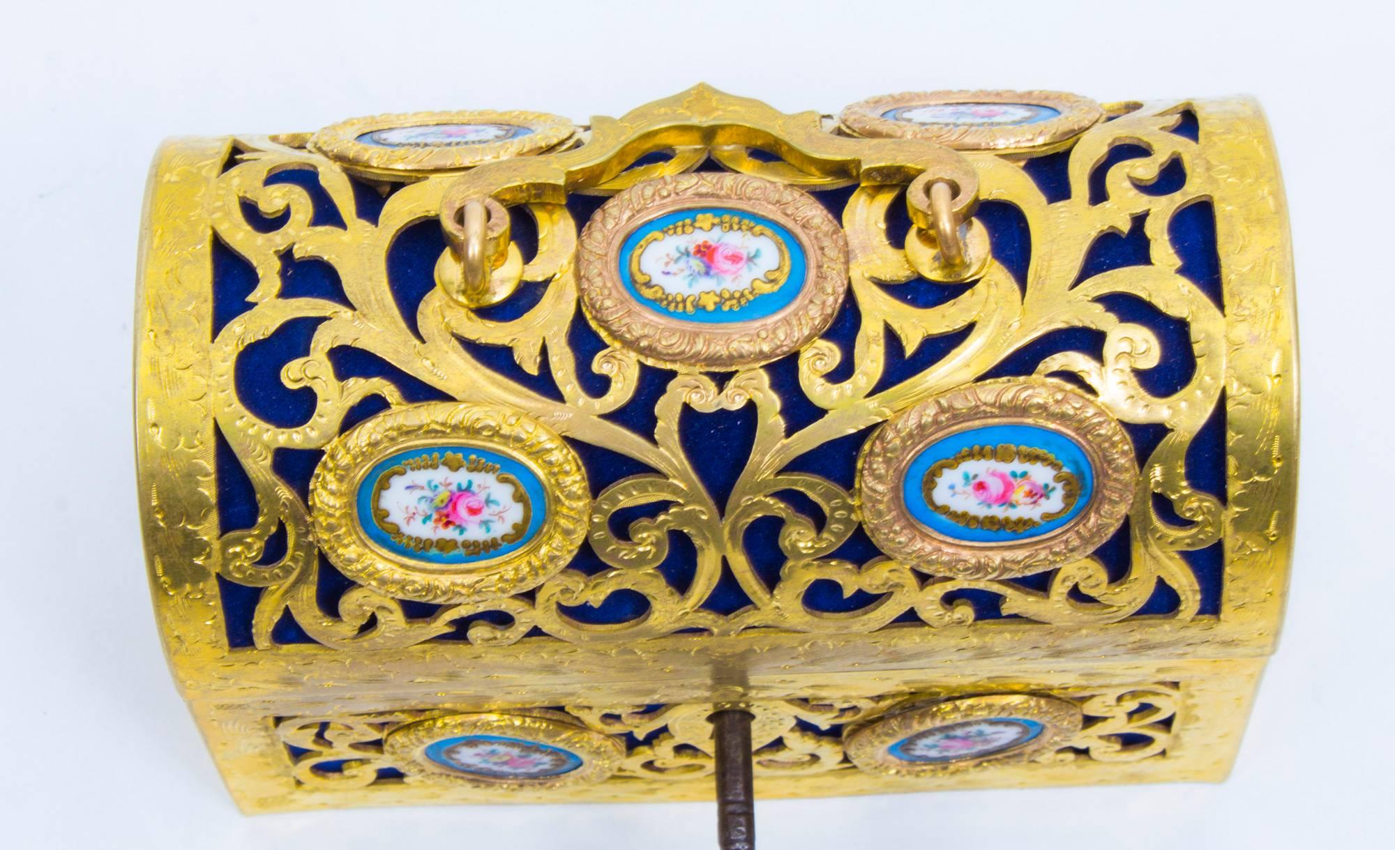 This is a stunning antique 19th century French gilt bronze casket set with florally painted Sevres porcelain panels. 

Of pierced scrolling domed form the casket opens to reveal a beautiful Royal Blue velvet lined interior.

Complete with