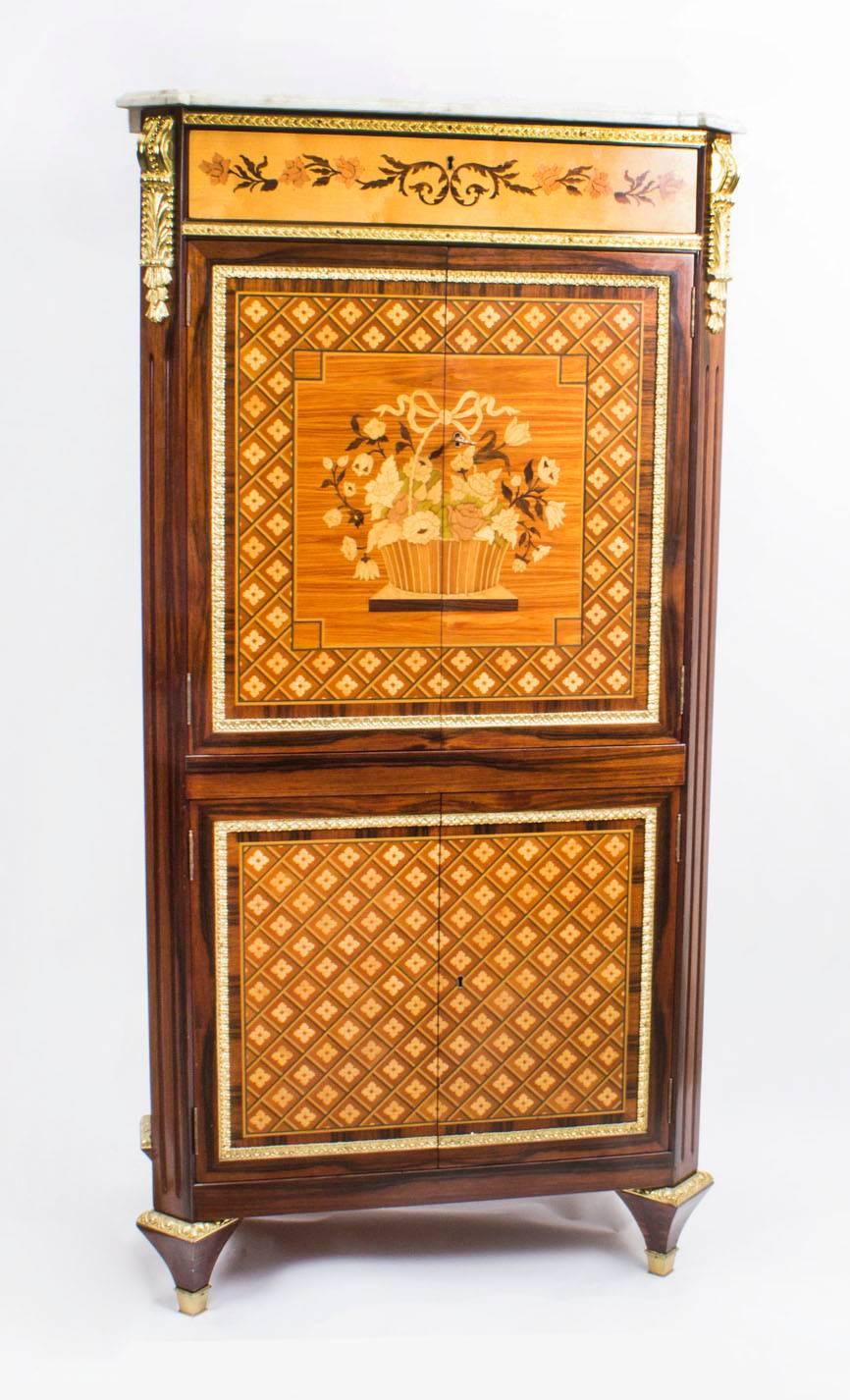 This is a stunning Louis Revival ormolu-mounted parquetry and marquetry cocktail cabinet dating from the third quarter of of the 20th century and retailed by Meubles Francais.

Of rosewood with tulipwood, satin birch and mahogany, the pair of top