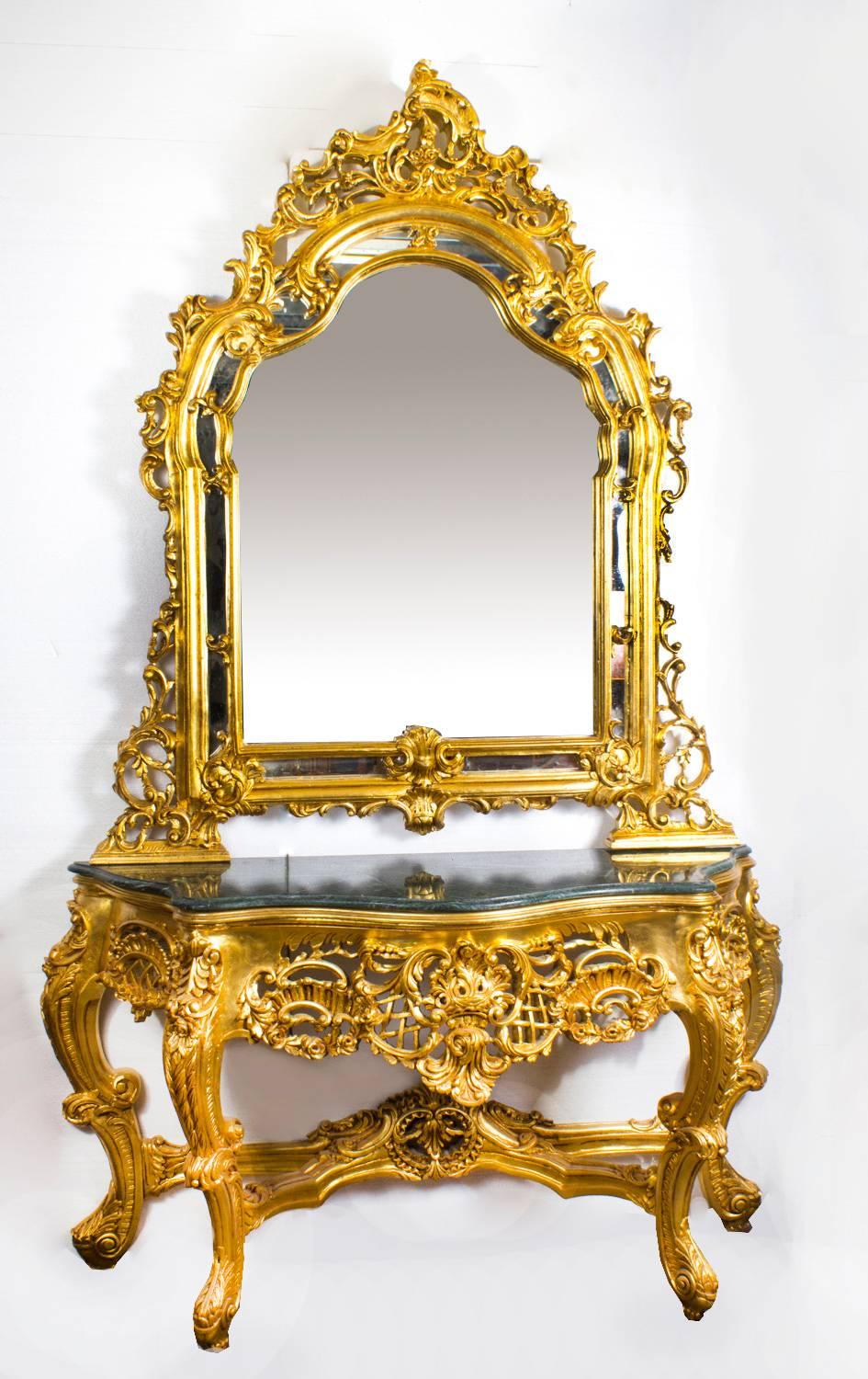 A highly ornate and absolutely stunning Louis Revival carved giltwood console table with matching mirror dating from the late 20th century.

The console table features an attractive green 'Verde Antico' marble top of the highest quality.

There