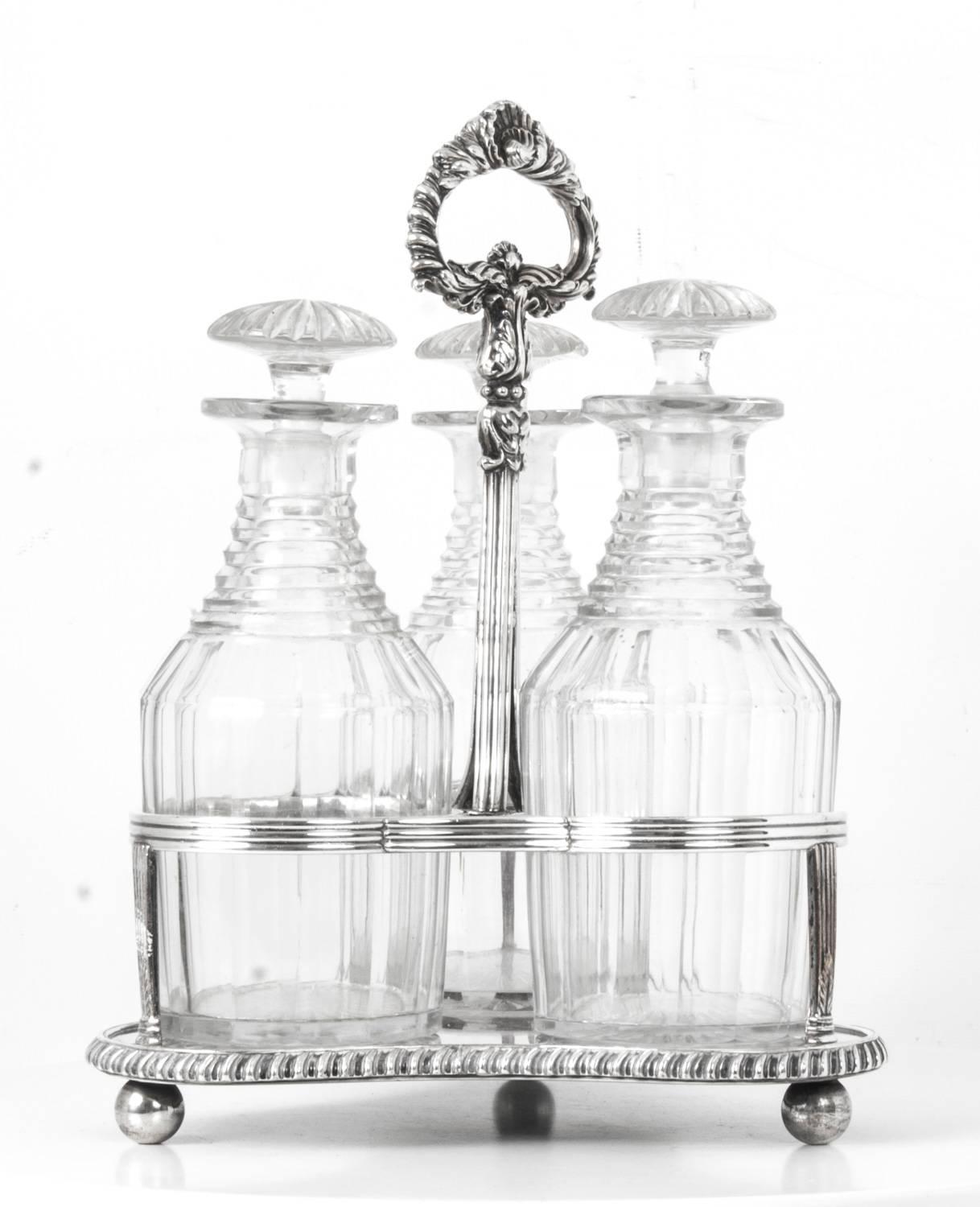 This is an attractive silver plated Georgr IV Old Sheffield silver plate trefoil three bottle decanter Stand with three cut-glass decanters by the renowned designer and silversmith Matthew Boulton, circa 1820 in date.

The silver plated decanter