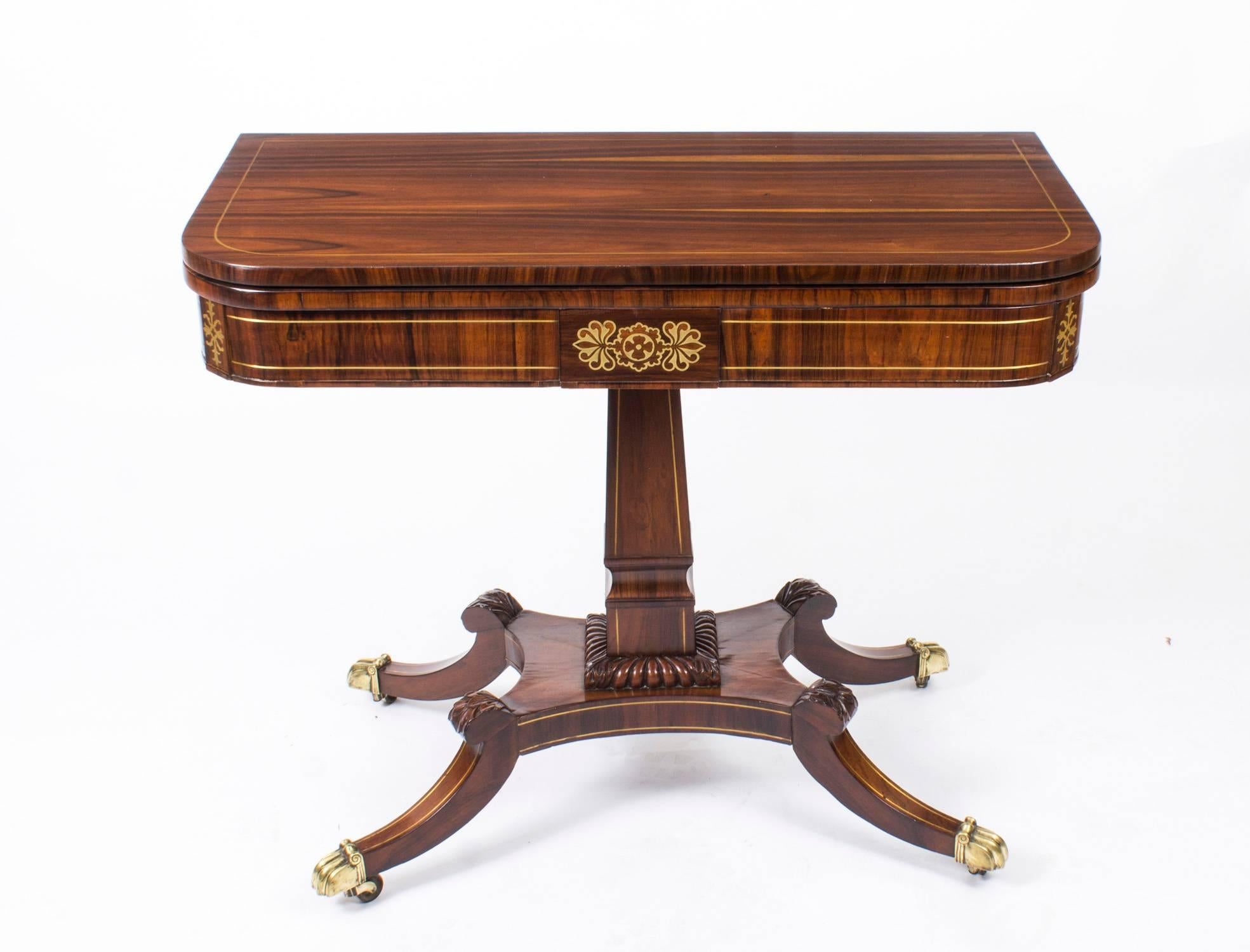 This is a very attractive antique English Regency coromandel and cut brass marquetry fold over card table, circa 1815 in date.

This rounded rectangular card table is made from beautiful coromandel, the folding top enclosing a baize lined green