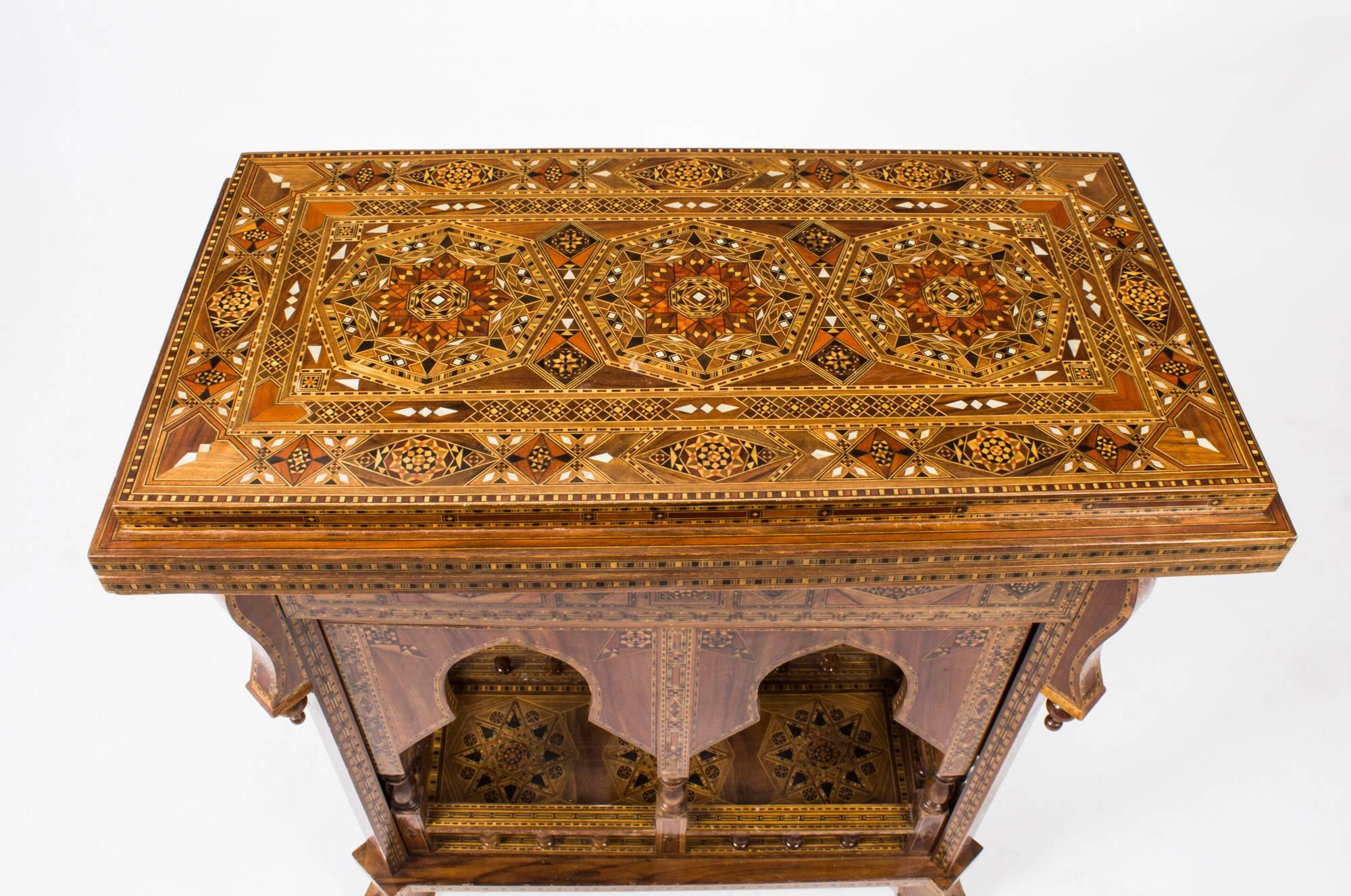 This is a profusely inlaid Syrian Parquetry games table, circa 1900 in date.

This games table is multi-functional, when closed it can be used as a side table, when open it becomes a card table, a chess or draughts table, or a backgammon table. It