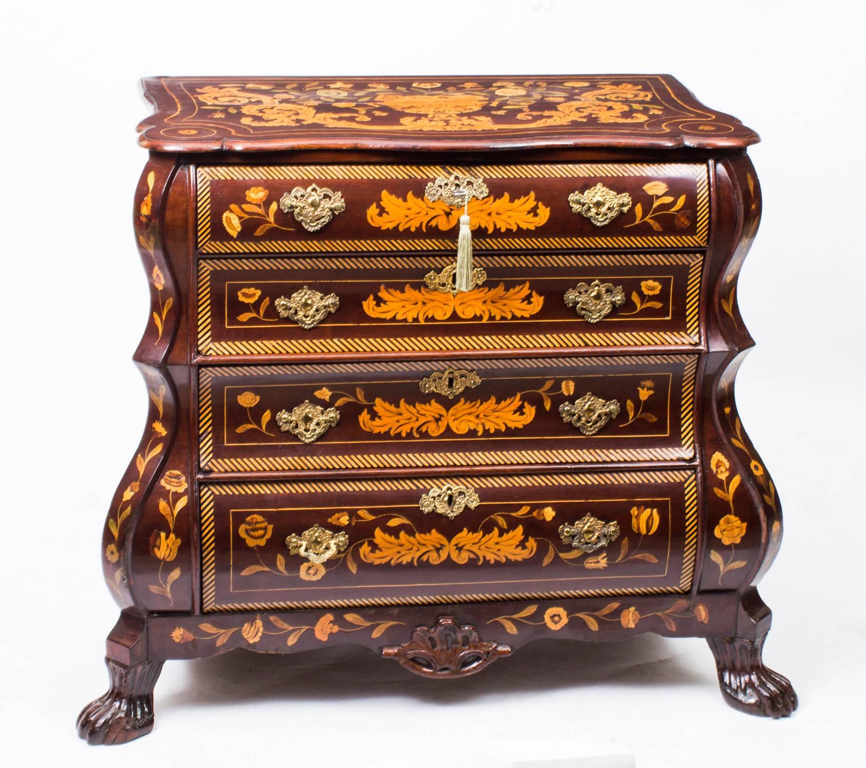 A 19th century Dutch marquetry chest of drawers, four drawers with brass drop handles flanked by canted angles and raised on paw feet. 

This is a stunning antique Dutch bombe' serpentine fronted marquetry chest of drawers, late 18th century in