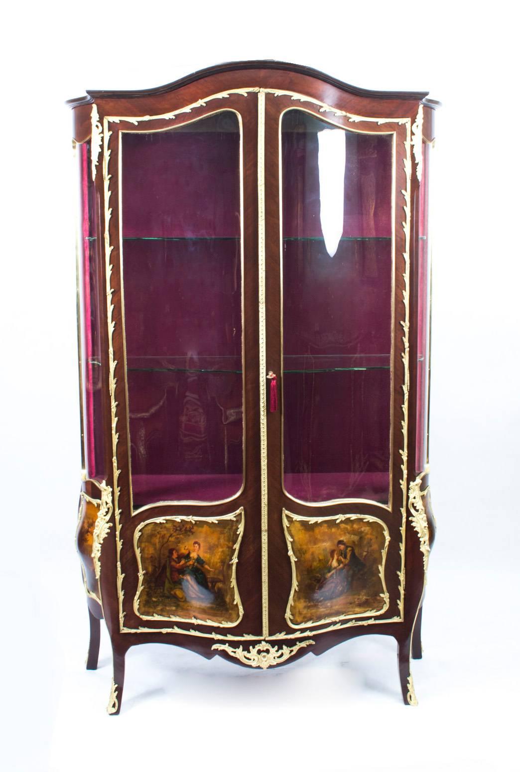 A stunning antique French kingwood and Vernis Martin serpentine vitrine in the Louis XV manner, circa 1880 in date.

It has three quarter glazed panelled doors with exquisite hand-painted decoration and exquisite ormolu mounts. There are four