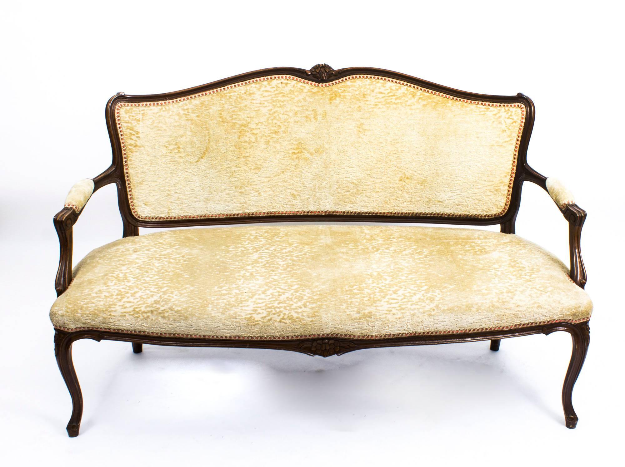 This an antique French sofa, circa 1900 in date.

This sofa was made from solid walnut and has been beautifully reupholstered in Fine fabric from the exclusive Beacon Hill range of fabrics.

It has wonderful hand-carved decoration and is raised
