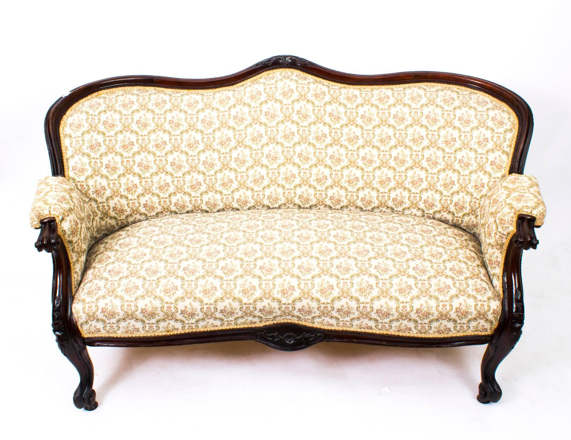 This is a stunning antique Victorian mahogany two-seat settee, circa 1870 in date.

The sofa has been hand-carved in mahogany and has a serpentine back, scrolled arms and cabriole forelegs.

It is luxuriously upholstered in a fine cream patterned