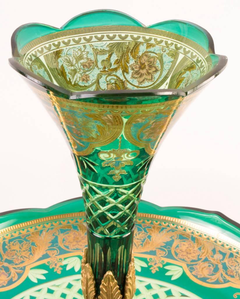 This is a beautiful large emerald green cut-glass and ormolu French epergne or centrepiece.

It is beautifully complimented with hand-painted enamelled decoration as well as expertly cut-glass and exquisite elaborate gilded ormolu mounts.

The