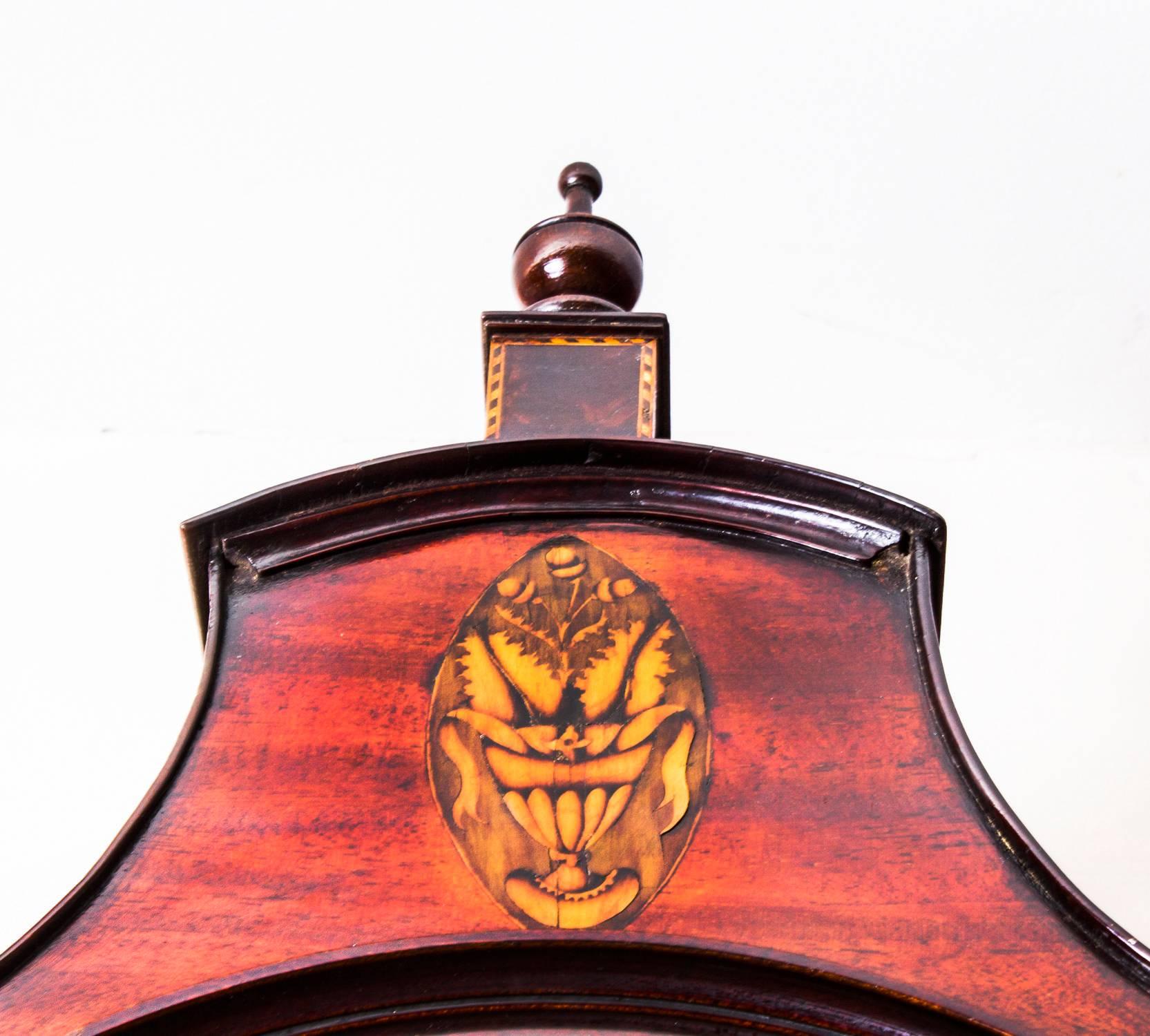 This is a stunning antique late 18th century flame mahogany 8 day English longcase clock by William Pridgin of Hull.

The arched brass and silvered dial with Roman and Arabic numerals and Rococo scroll cast spandrels, with an eight day four pillar