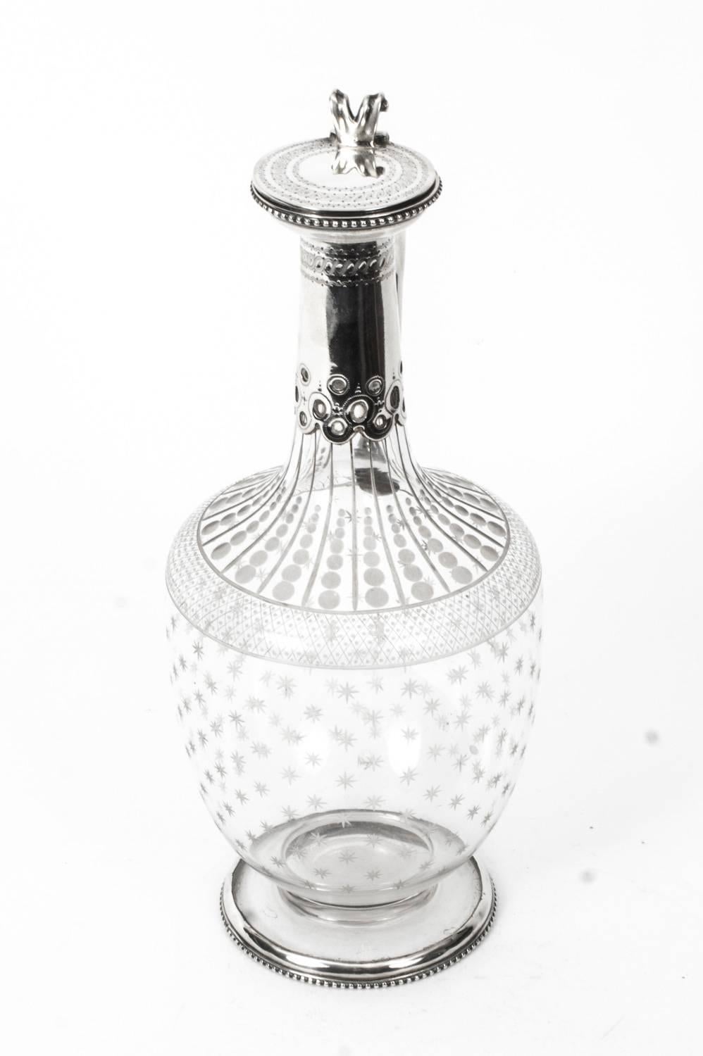A superb antique neoclassical Victorian sterling silver and crystal claret jug, with hallmarks for London 1875 and the makers mark of Daniel & Charles Houle.

The piece has a superbly engraved crystal body with a beautifully chased silver mounted