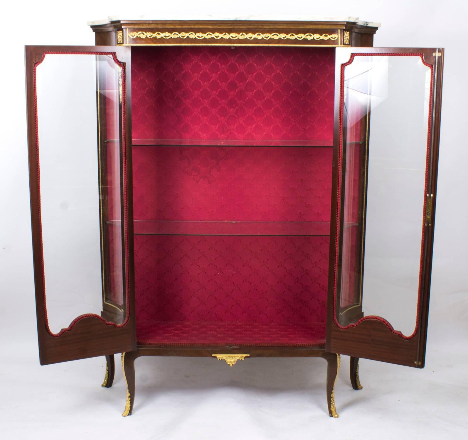 This is a wonderful antique French mahogany and ormolu-mounted display cabinet in the French Louis XV manner, circa 1880 in date.

This beautiful cabinet has an abundance of exquisite decorative ormolu mounts. It has a pair of glazed doors to the
