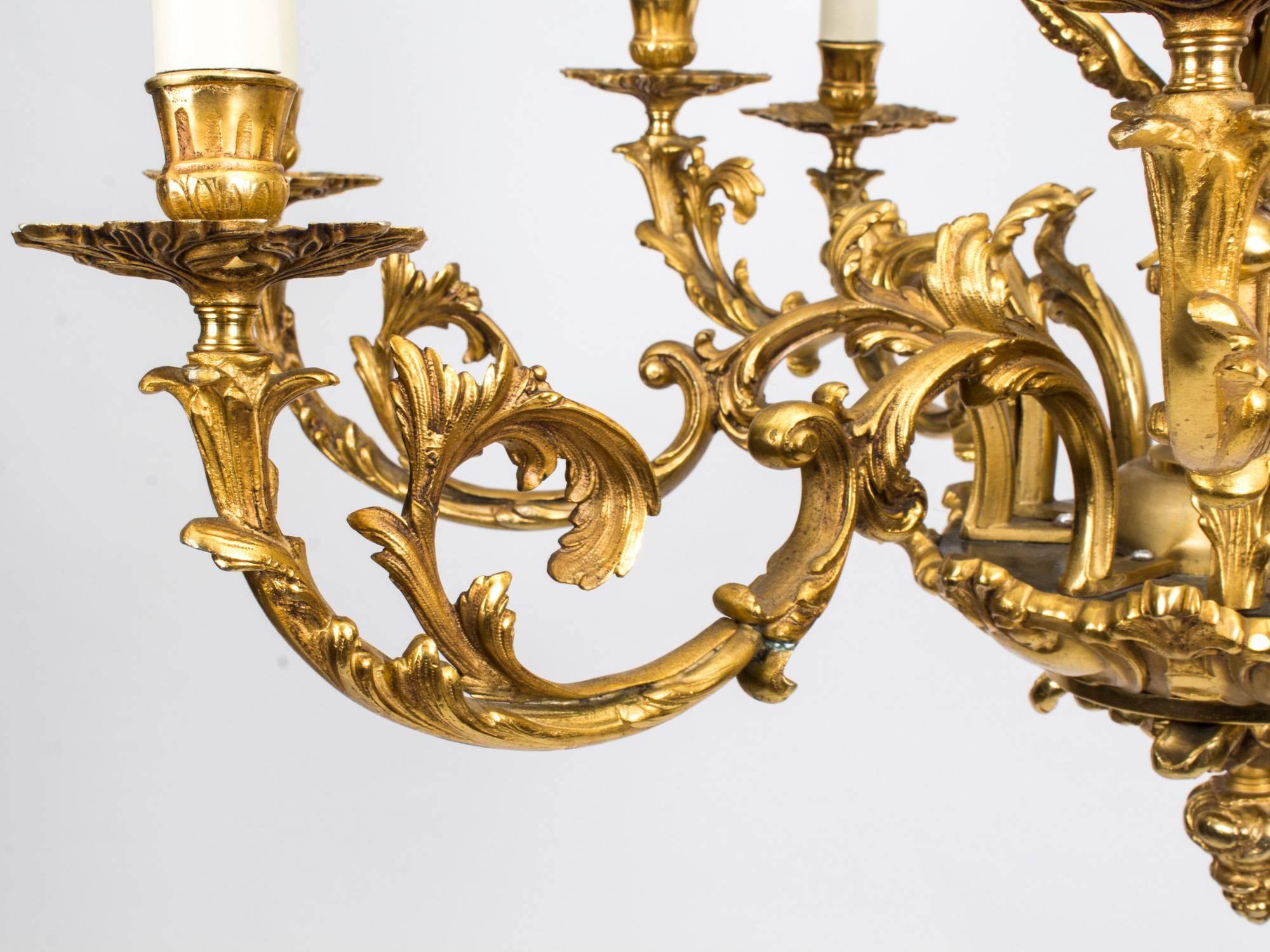 This is a highly decorative French mid-19th century Louis XIV style nine branch ormolu chandelier in the manner of Andre Charles Boulle, circa 1870 in date.

Emanating from a central column, the upper part is dressed with three female caryatids