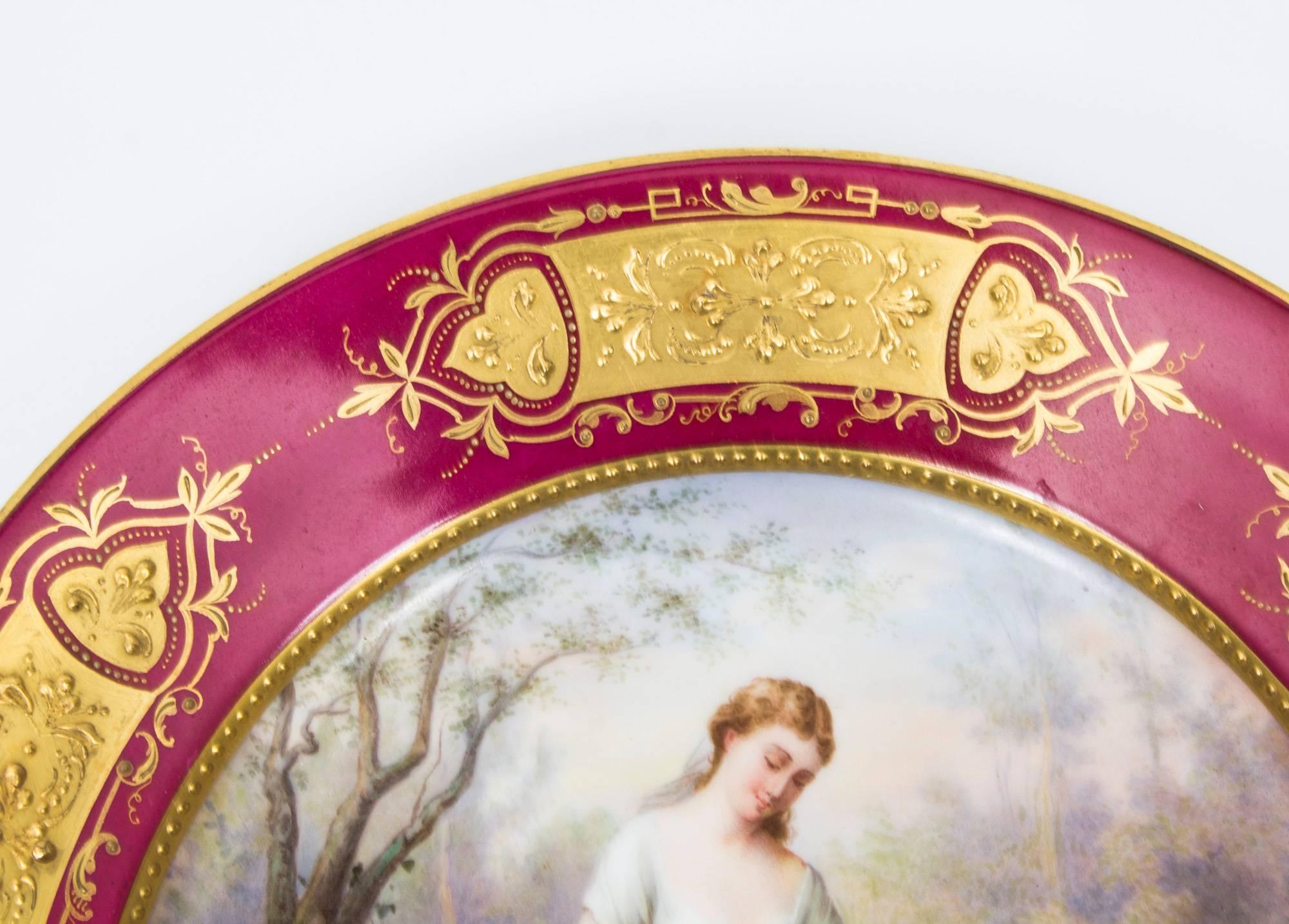 A wonderful antique Vienna porcelain cabinet plate, circa 1880, of circular form, beautifully hand-painted with a mother reading to two young boys, titled Marchen (The Fairy Tales) within a stunning beaded gilt cartouche, the rim with five panels