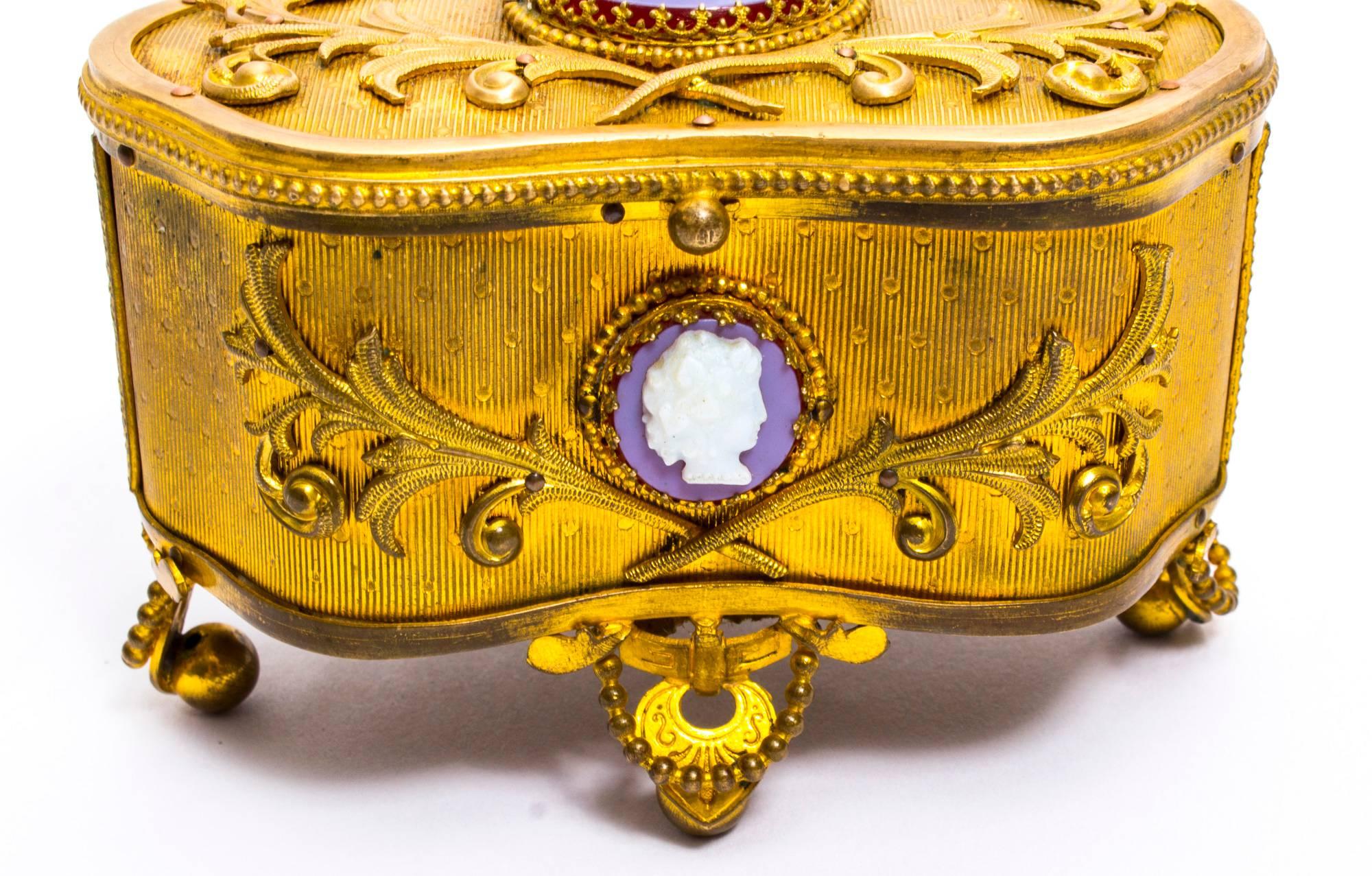 This is a beautiful antique French Napoleon III gilded ormolu Jewelry casket, circa 1860 in date.

The top, front, sides and back are beautifully cast and tooled in gilt bronze with superb foliate decoration and it is further decorated with three
