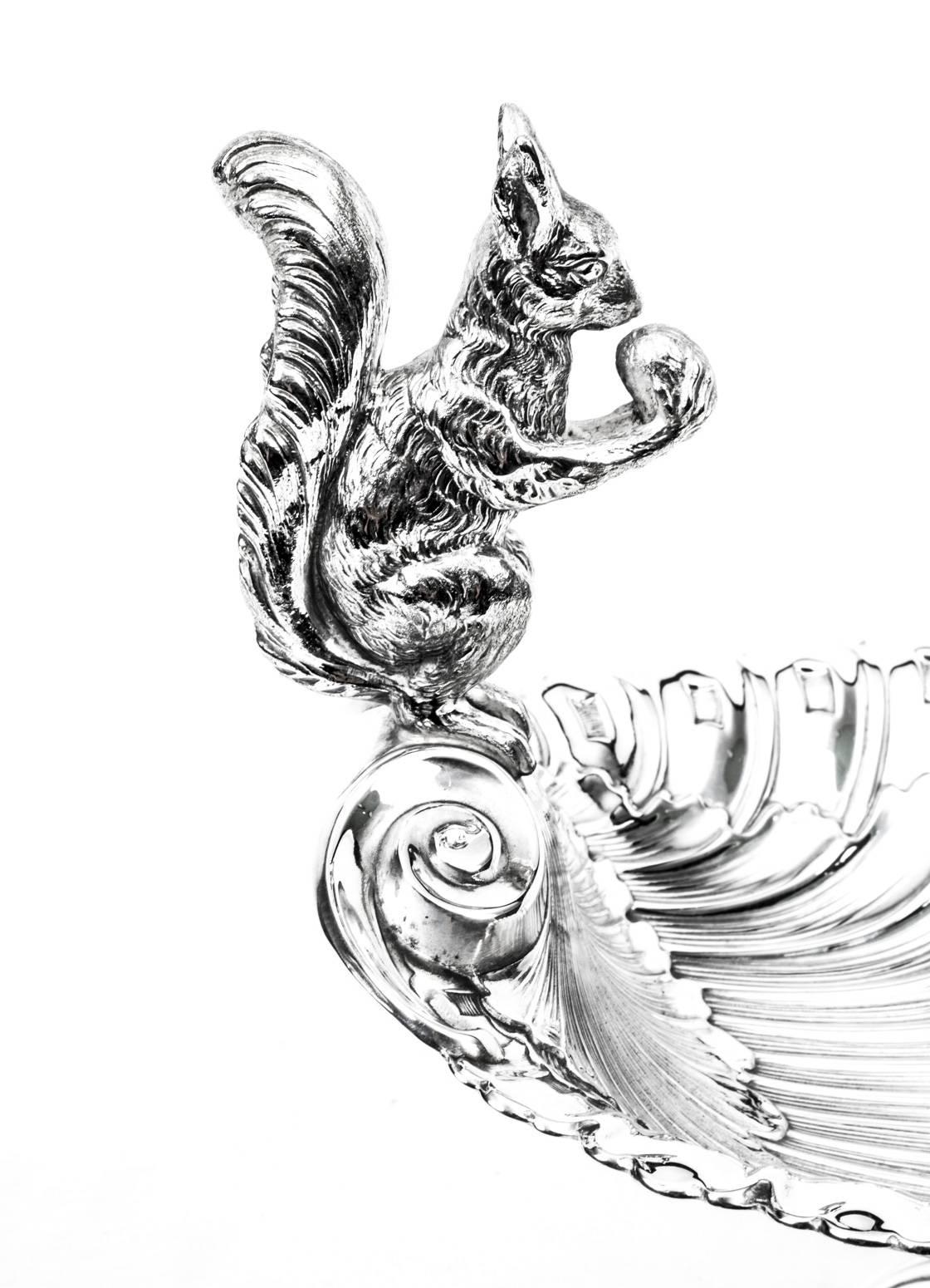 This is a stunning antique English Victorian silver plated nut dish or fruit basket with fabulous shellembossed decoration, circa 1880 in date.

It bears the mark EPNS for electro plated nickel silver, and has a fabulous squirrel eating a nut