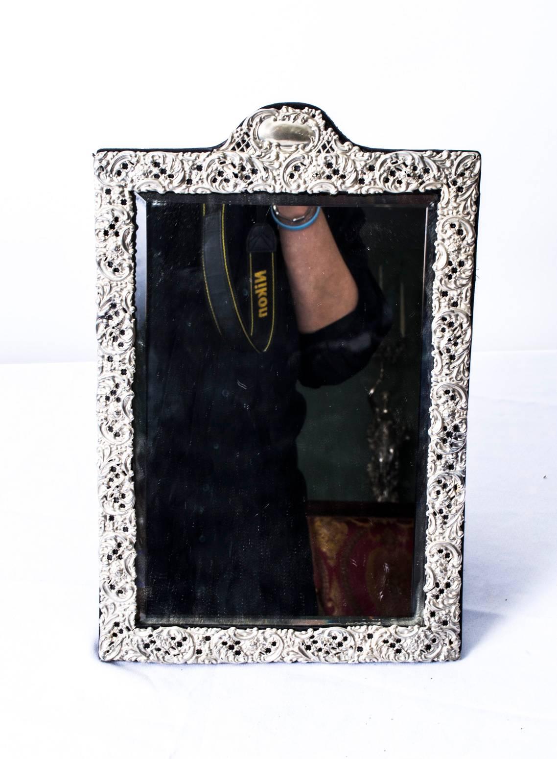 This is a wonderful antique English Victorian sterling silver mounted rectangular easel dressing table mirror with hallmarks for Birmingham 1902 and the makers mark of Levi & Salaman, the renowned silversmiths that specialised in mirrors.

The