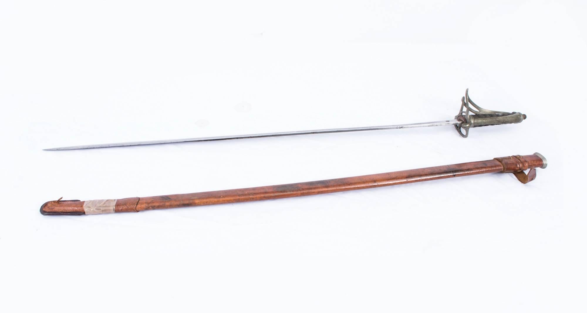 A superb George V Royal Artillery officers sword in leather mounted scabbard, circa 1910 in date.

The sword features a silvered openwork and shagreen hilt with a single etched blade, double edged at the point, cut with a long deep central fuller