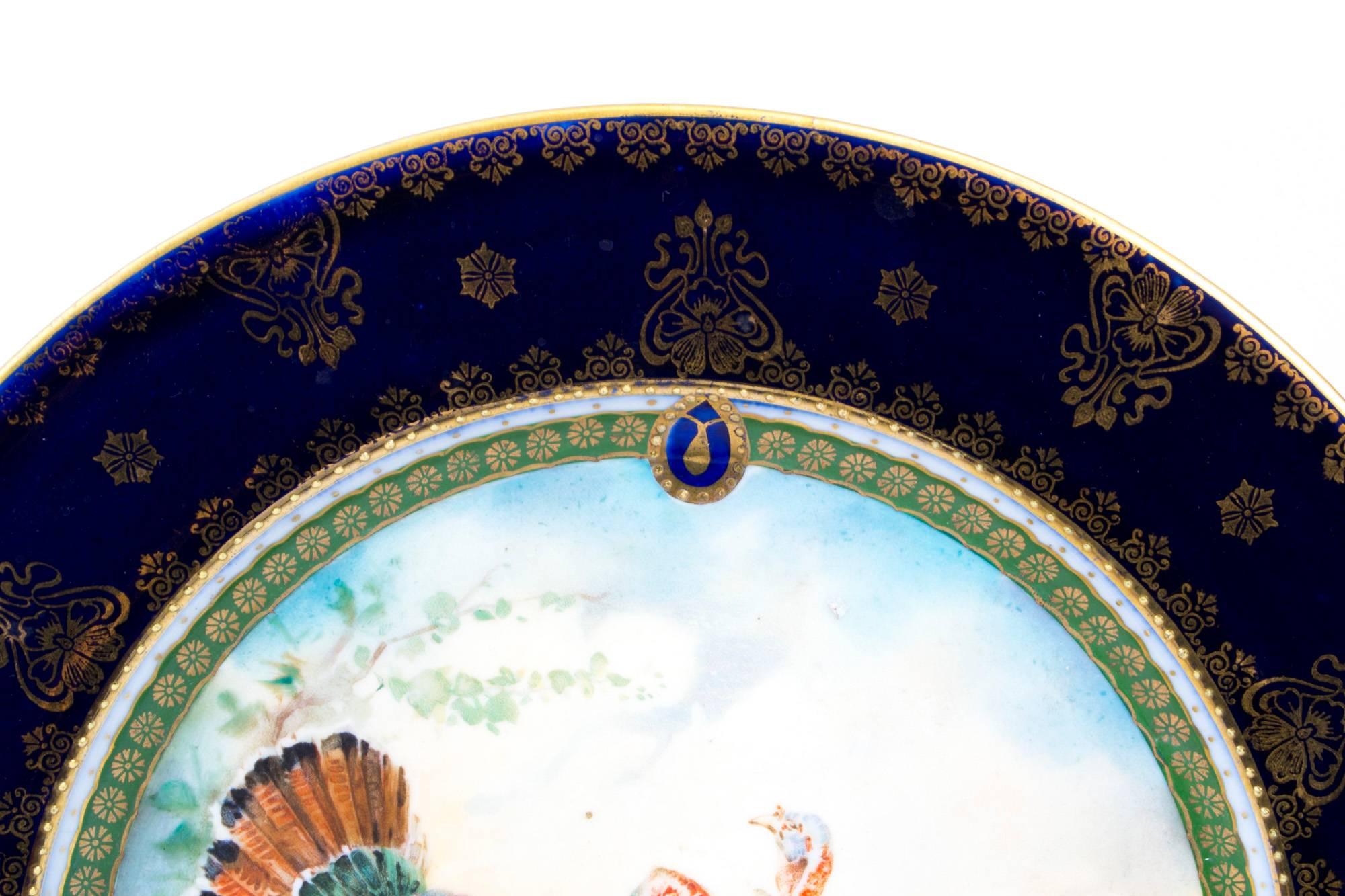 This is a wonderful antique Vienna porcelain cabinet plate, circa 1900 in date.

It is beautifully hand painted with a pair of turkeys in a landscape, and bearing the blue underglaze "beehive" mark.

There is no mistaking the unique