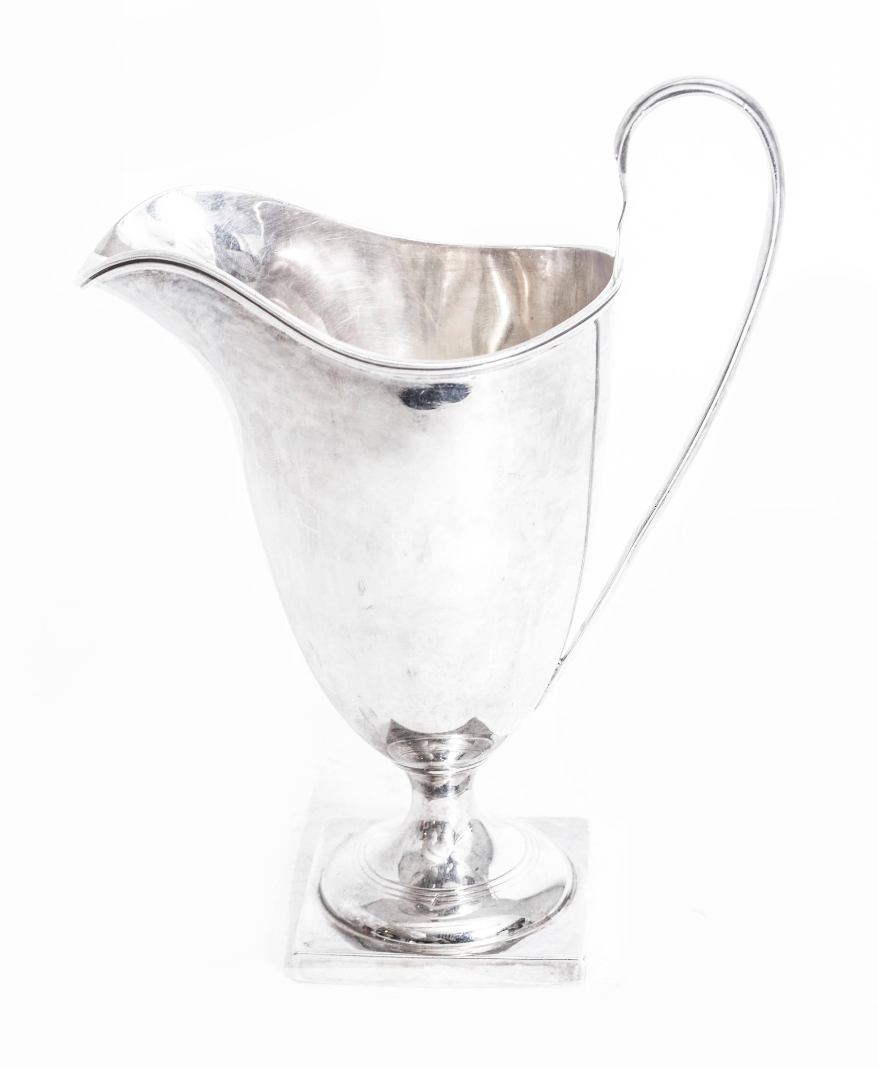 This is an exquisite antique Edwardian sterling silver helmet shaped cream jug with hallmarks for Chester 1906 and the makers mark of the renowned silversmiths George Nathan & Ridley Hayes.

There is no mistaking its unique quality and design, which