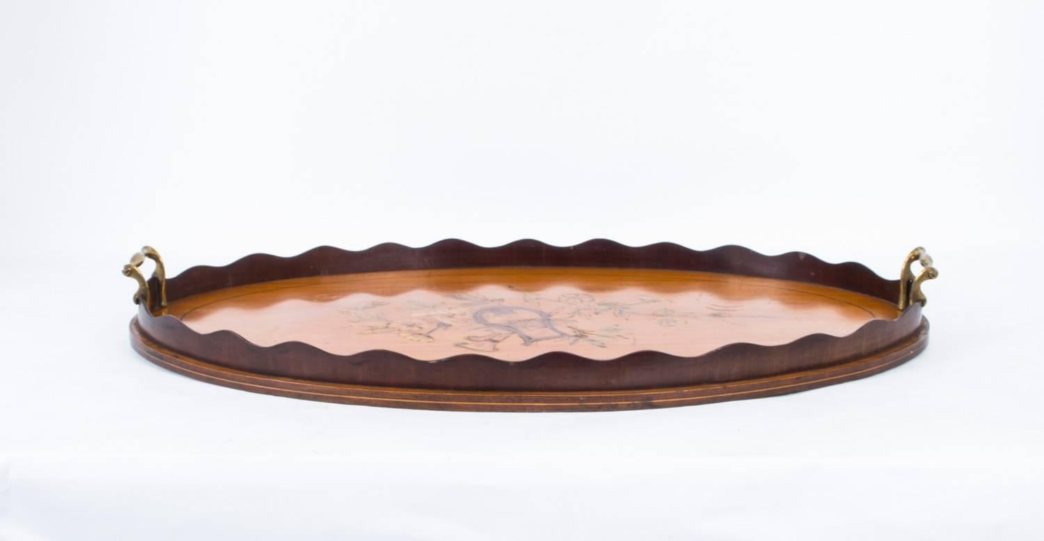This is a beautiful antique Edwardian satinwood drinks tray with shaped gallery, circa 1900 in date.

The tray has elegant brass carrying handles and is inlaid with a fabulous marquetry of musical motifs.

It is a simple yet very elegant item