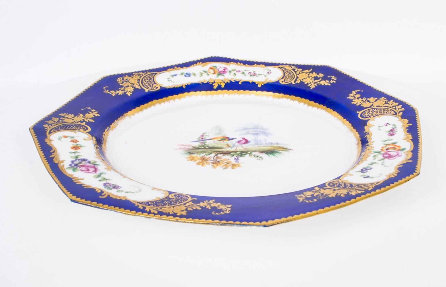 This is a beautiful antique octagonal Sevres porcelain cabinet plate, circa 1880 in date.

The centre hand-painted with fanciful birds, the rim with three oval cartouches, each with summer flowers on a beautiful cobalt blue ground with gilt dental