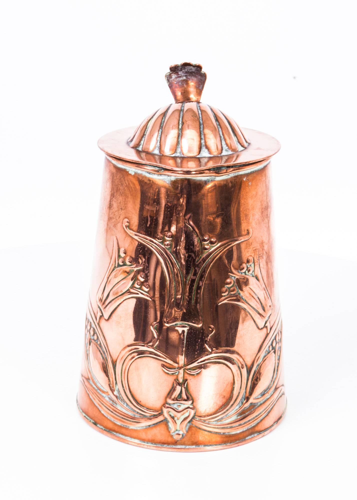 This is a wonderful antique English Art Nouveau Edwardian copper lidded jug by Joseph Sankey & Sons, circa 1910 in date. 

The copper has wonderful art nouveau stylised floral decoration in low relief and a shell and handle in high relief