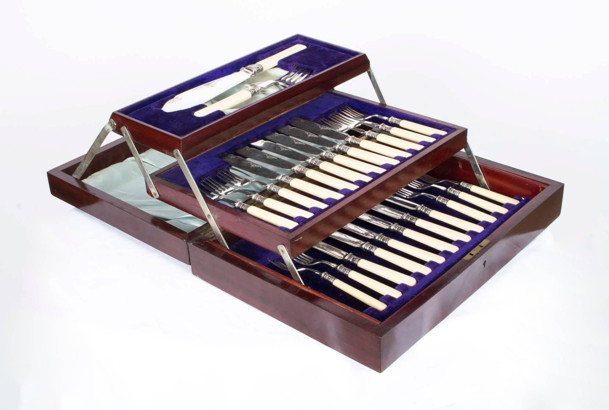 This is a beautiful antique English set of twelve silver plated fish knives, fish forks with a pair of large servers, with the silver hall marks on the collars for Sheffield, 1923, and the makers mark JY for Yates Brothers of Sheffield, England,