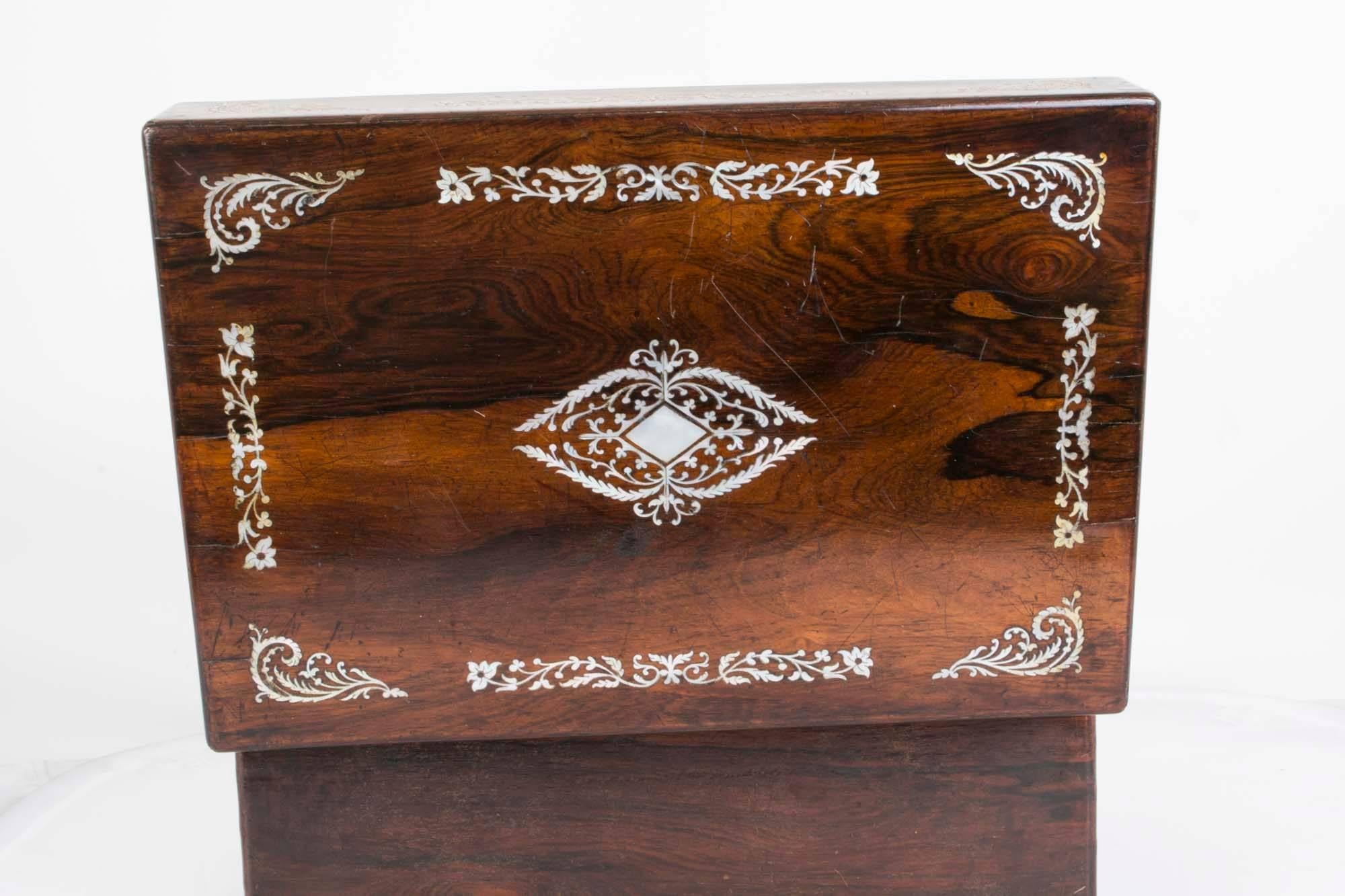 This is a fabulous antique Victorian rosewood and mother-of-pearl vanity box, circa 1860.

The box has a fitted burgundy velvet interior with a removable tray and further compartments to store your jewellery or any small objects. There is also a