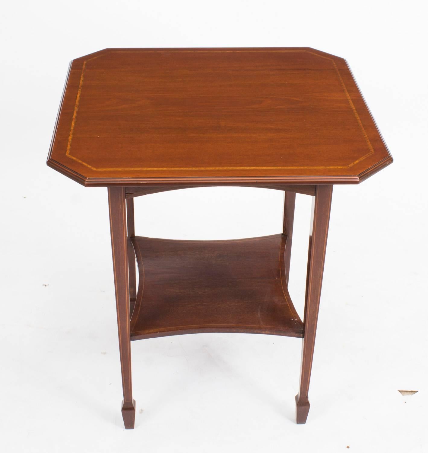 This is a pretty antique Edwardian occasional table, circa 1900 in date.

The table is exquisitely crafted in mahogany, features satinwood and boxwood line inlaid decoration throughout and it has a useful shelf underneath.

Add a touch of class to