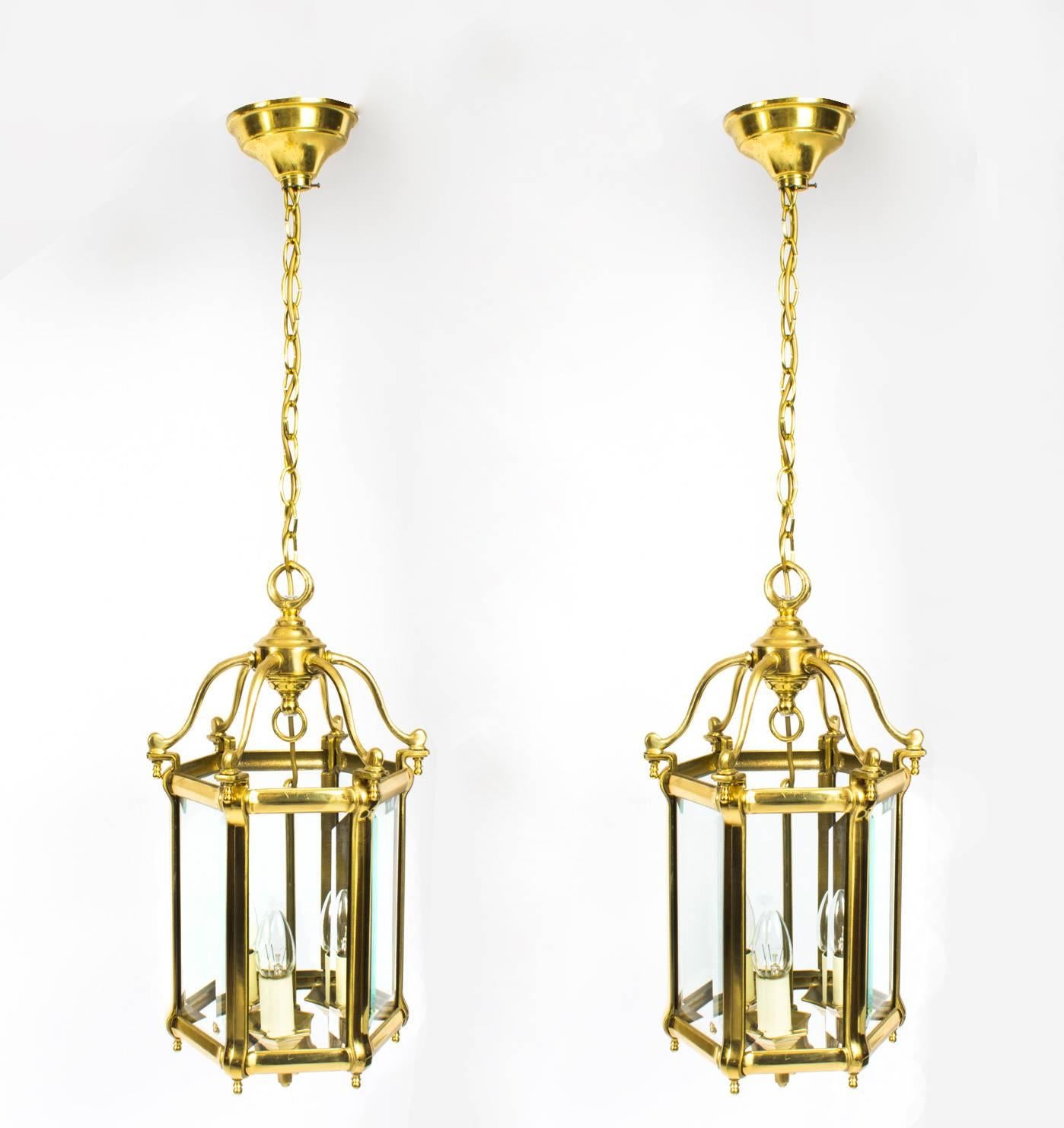 A stunning pair of Mid-Century brass hexagonal hall lanterns, each with six shaped arms supporting bevelled glazed panels enclosing three lights, circa 1960 in date.

Complete with pendant from a chain and ceiling rose.


Condition:
In excellent