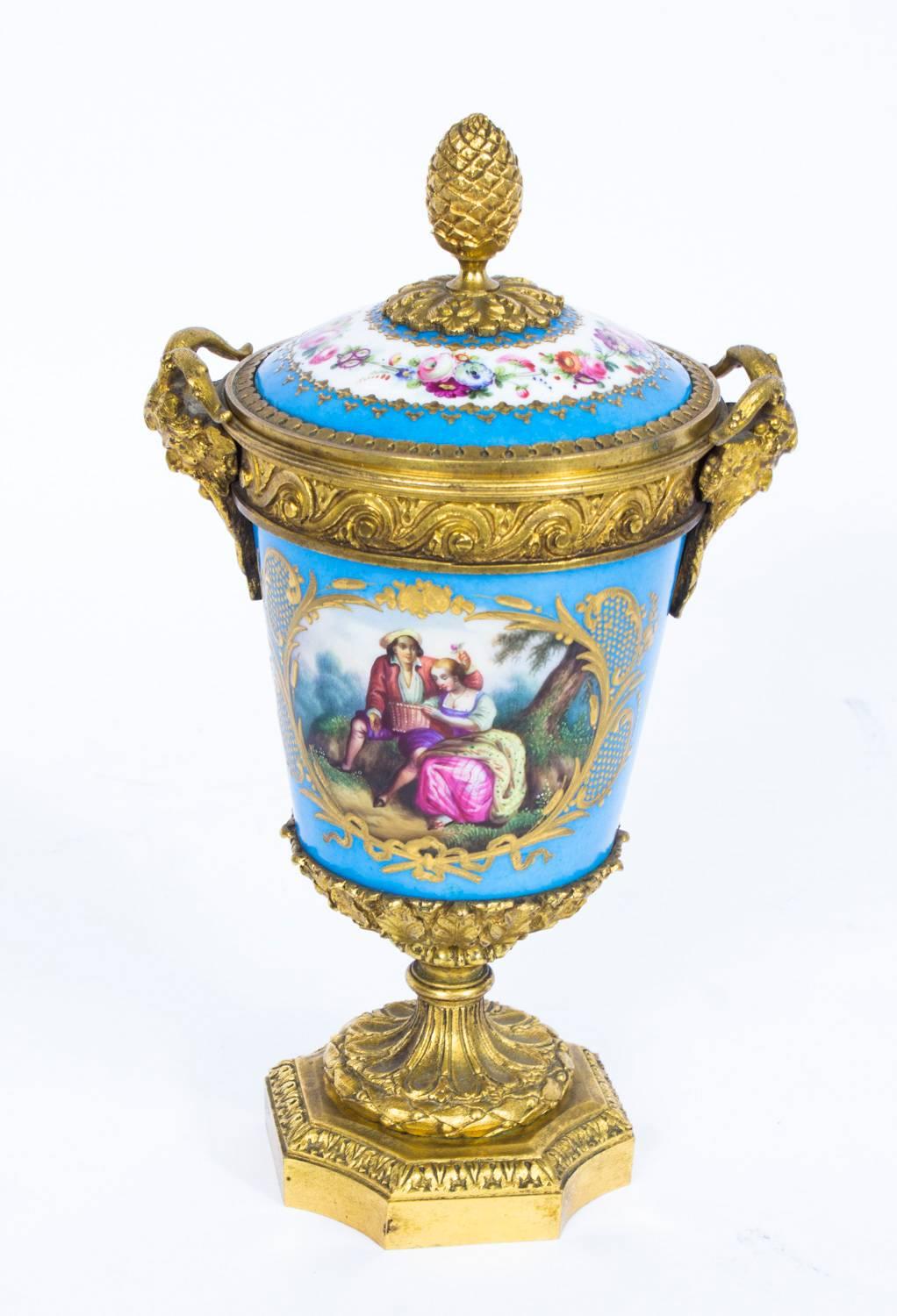 This is a beautiful antique pair of French Sèvres "Bleu Celeste" porcelain and ormolu-mounted garniture vases and covers, in Louis XV style, circa 1860 in date.

They are superbly decorated in the Sèvres manner with hand painted floral