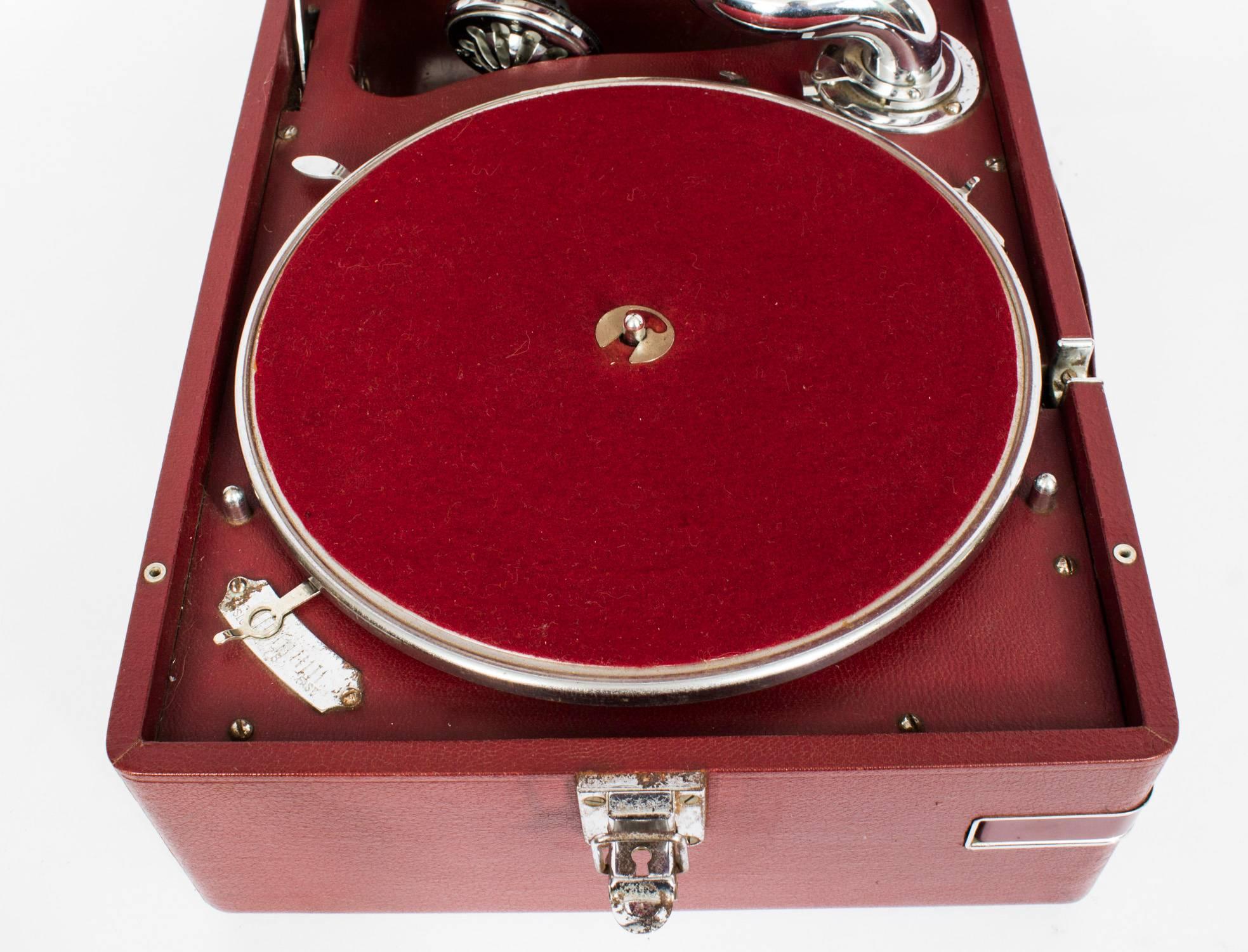 This really excellent portable gramophone was made by 'His Master's Voice' 

Model: 102 first made in 1931 and this one dates from 1935. 

Model No: 102 C

Serial no: 447398

This is a rare de-luxe variant in red leathercloth, a rare colour,