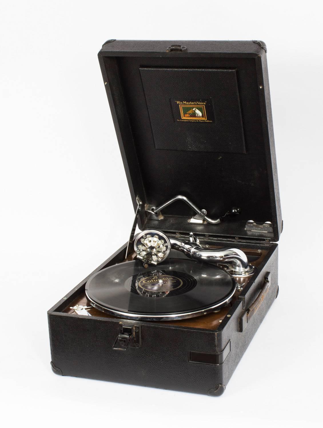 This really excellent portable gramophone was made by 'His Master's Voice' 

Model: 102 first made in 1931 and this one dates from 1935. 
Model No: 102 C
Serial no: 836859

This is the deluxe variant in black leather cloth. It was very popular